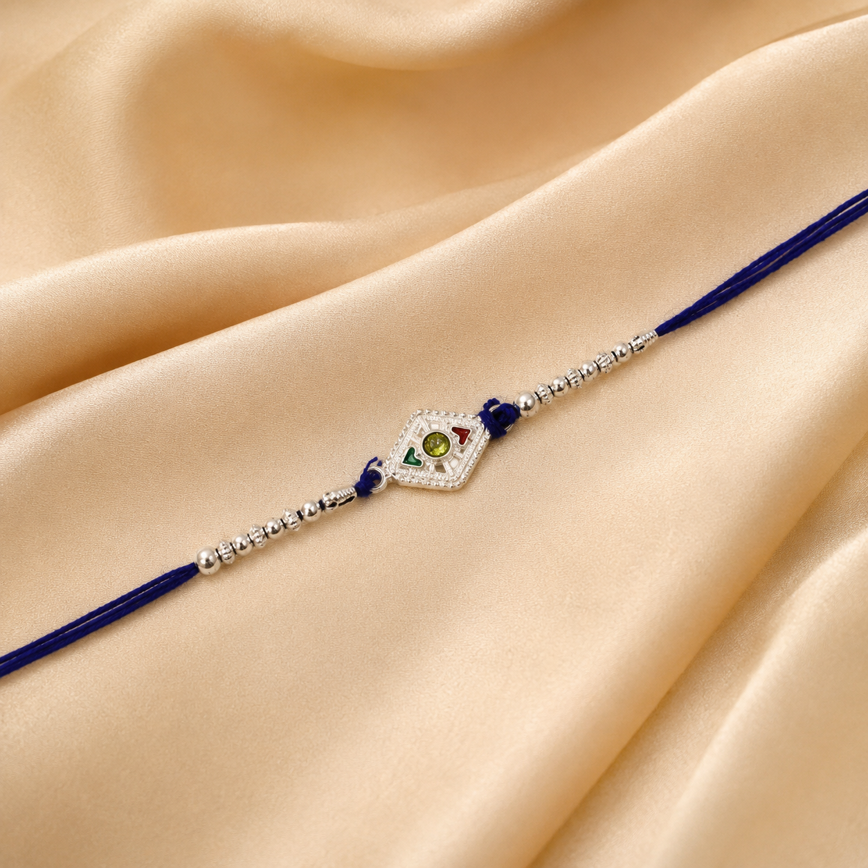 Stylish Silver Kite Rakhi featuring intricate stone and bead design.