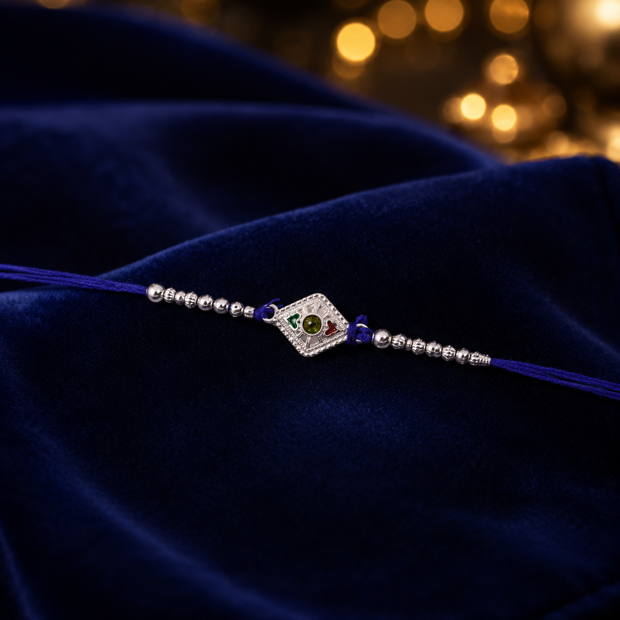 Detailed view of the stone charm and thread work on this unique Silver Kite Rakhi.