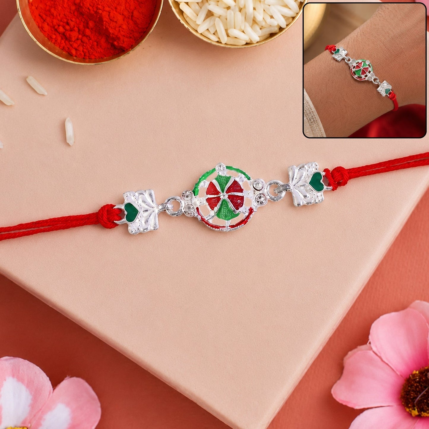 Silver pinwheel heart rakhi with red and gold thread