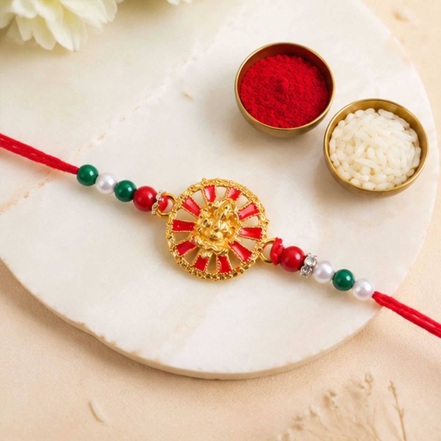 Decorative Golden Ganesha Wheel Rakhi with beads on festive thread