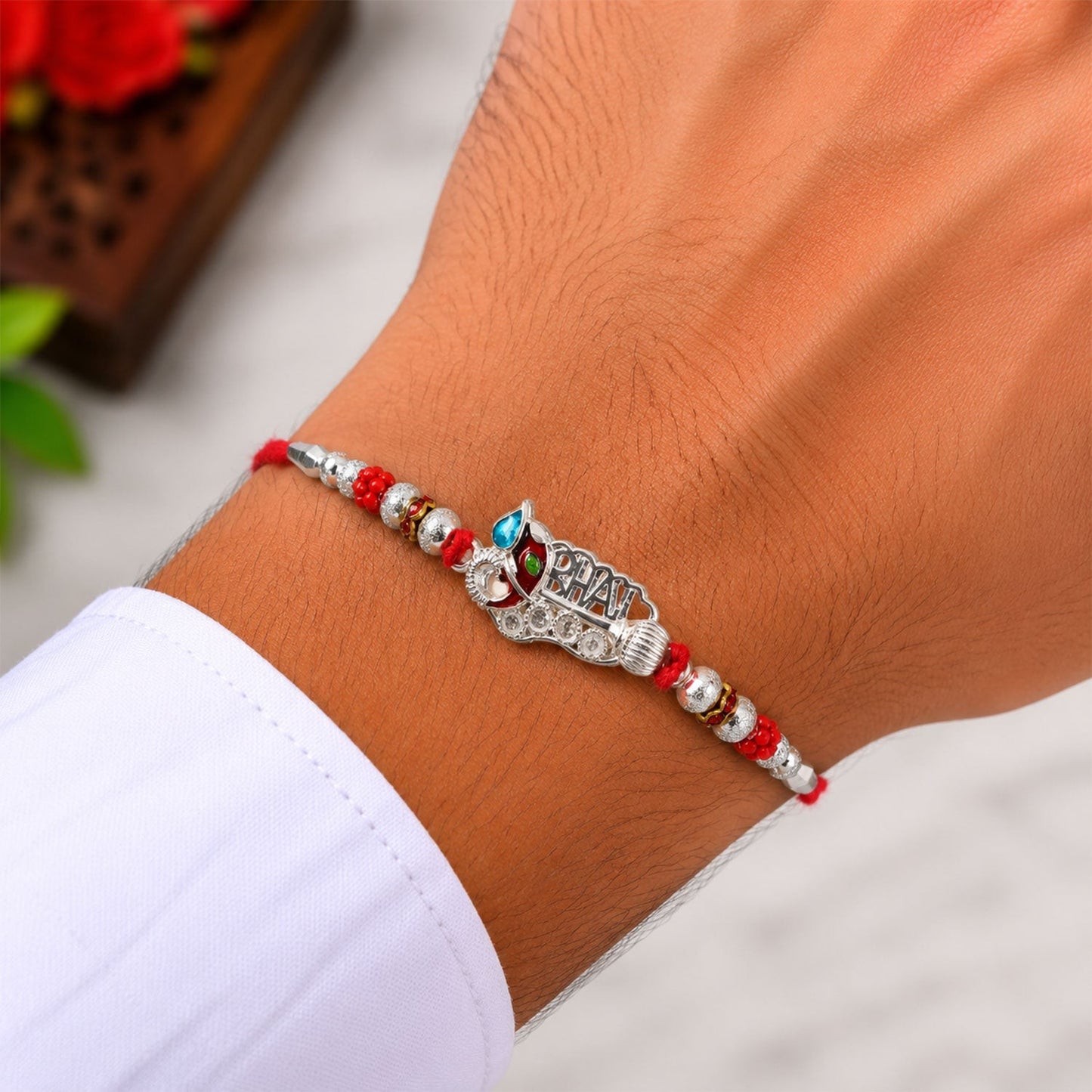 Stylish traditional rakhi with decorative beads and silver detailing