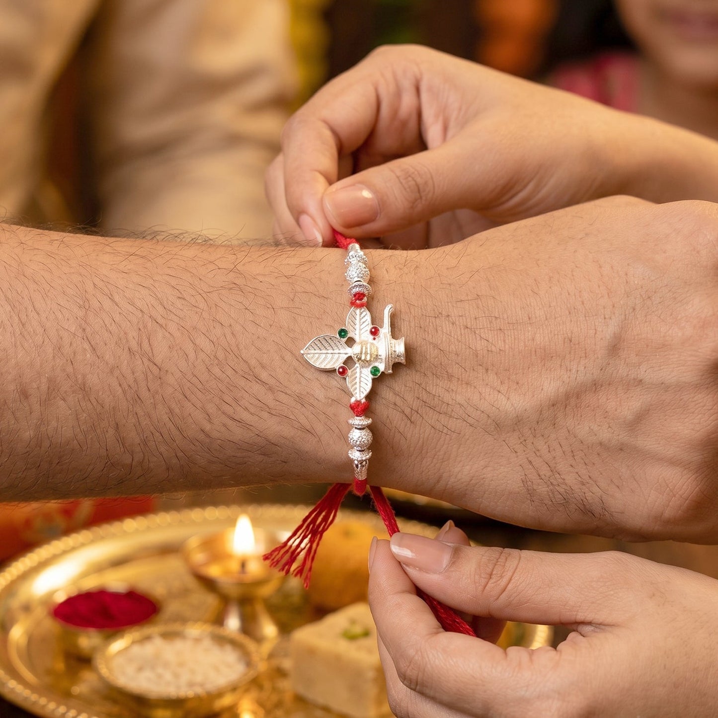 Elegant Silver Shiv Rakhi with intricate detailing and lightweight thread