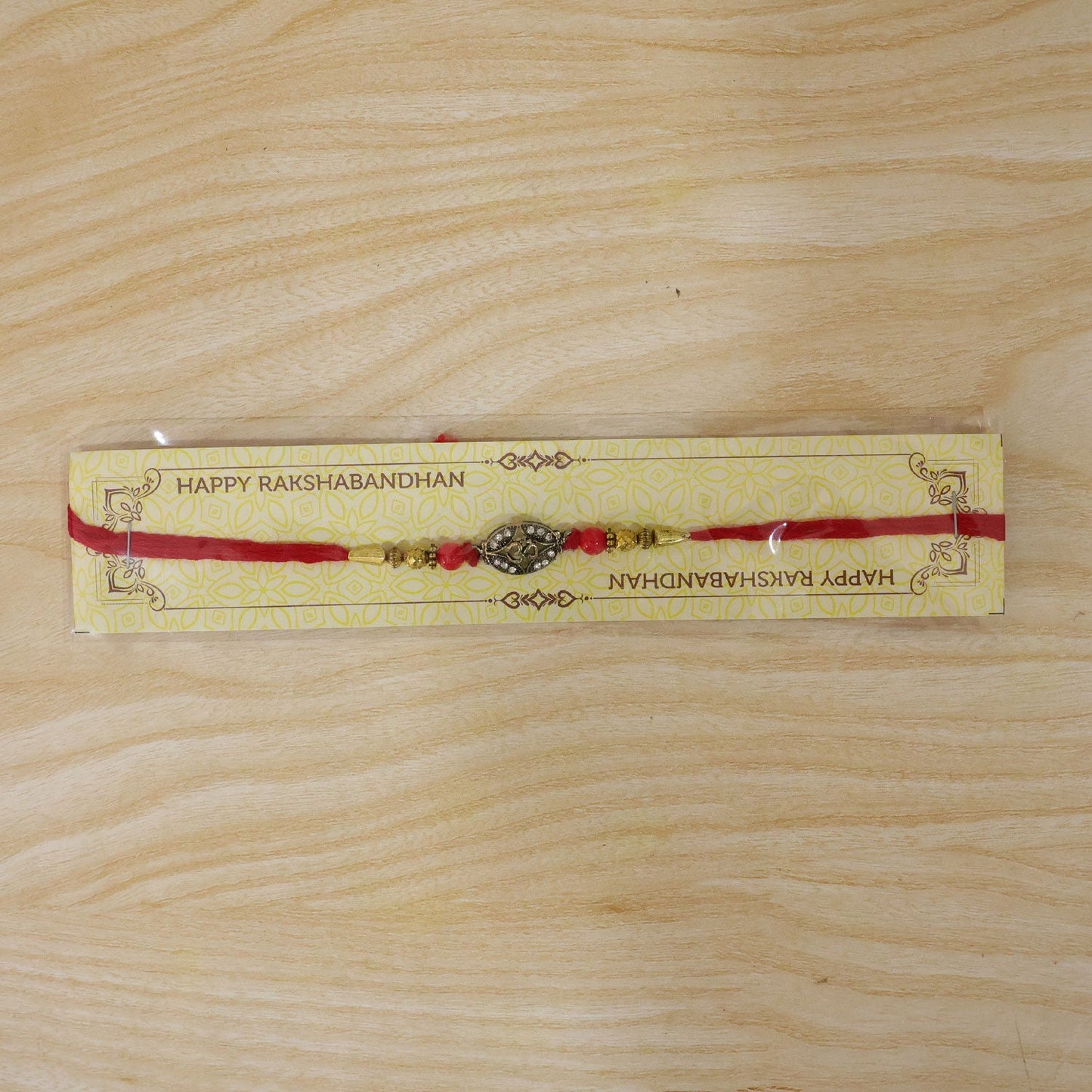 Elegant Rakhi with ornate centerpiece and decorative beads for festival celebrations
