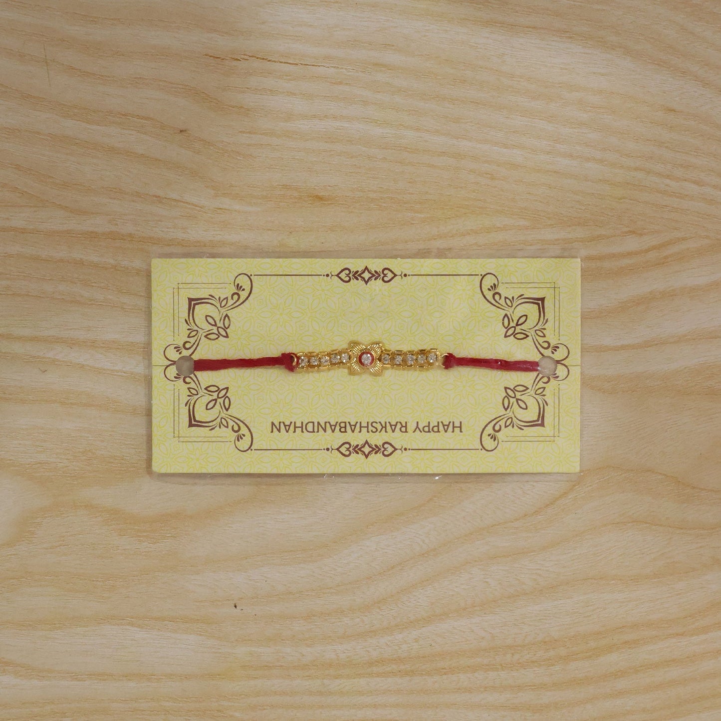 Festive rakhi with gold plating and sparkling diamonds