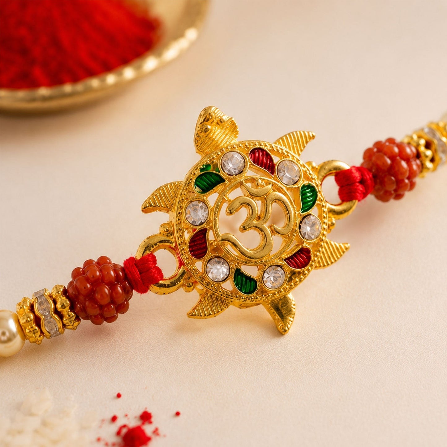 Close-up of intricate meenakari work on traditional rakhi for brother