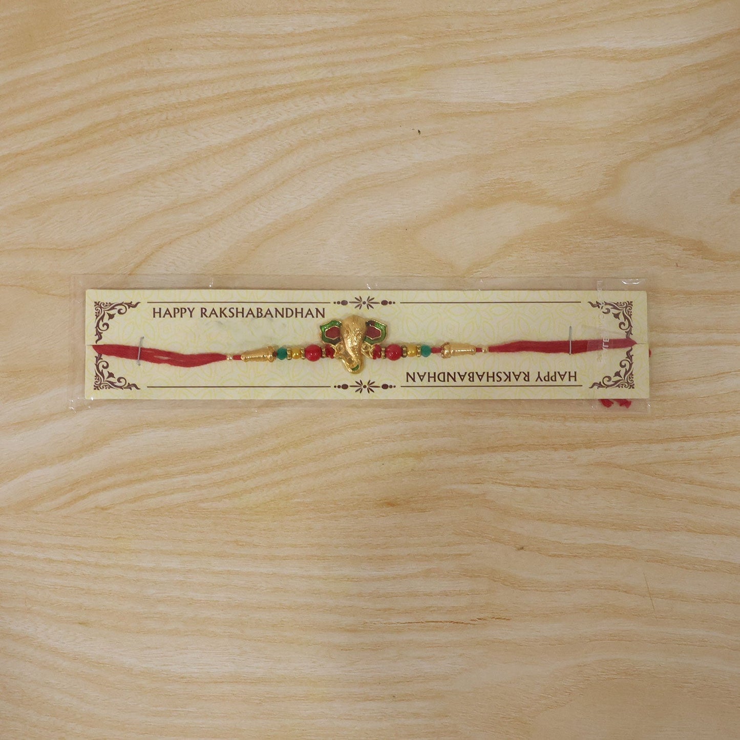 Elegant designer Ganesha Rakhi with intricate meenakari detail