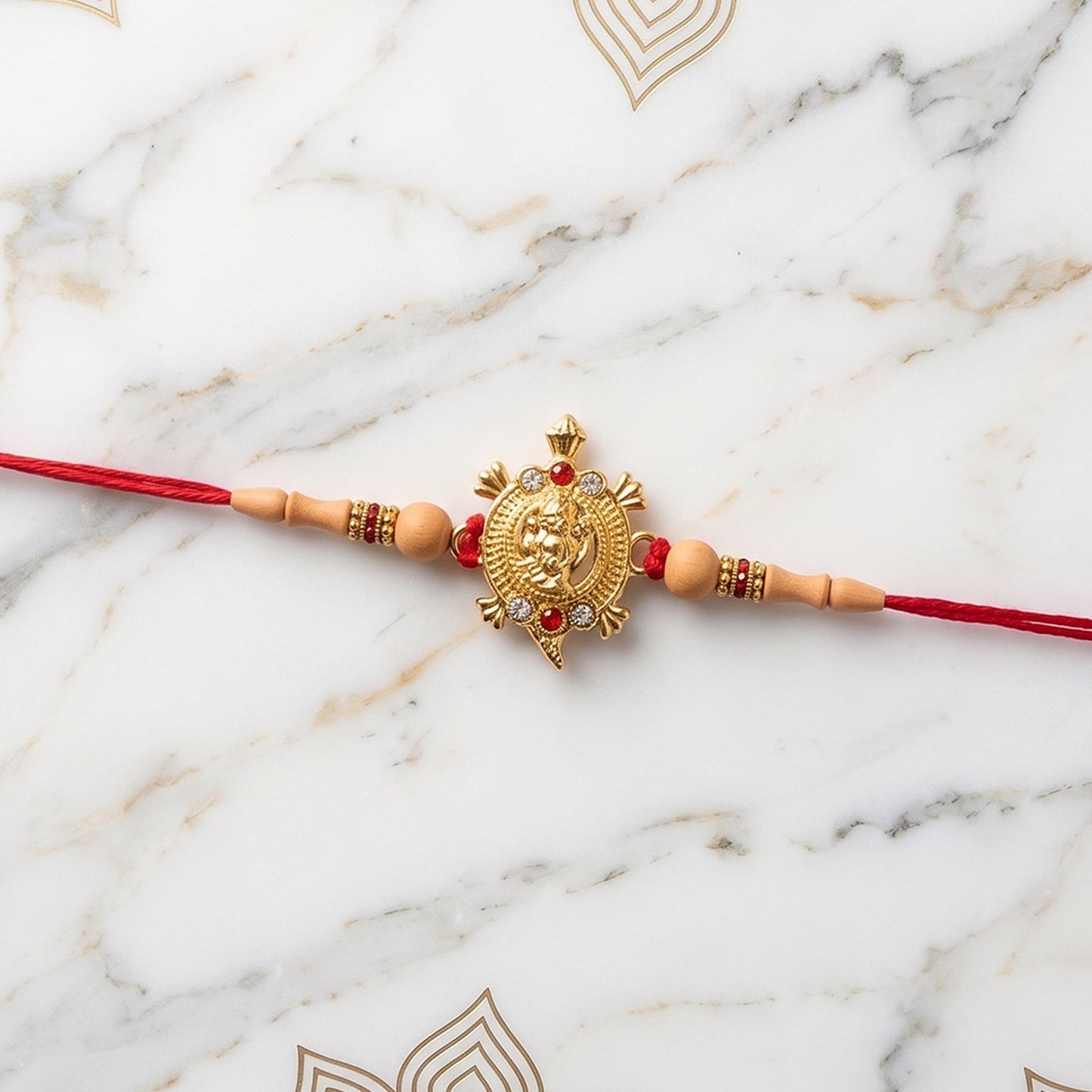 Beautiful Golden Om Rakhi with thread, suitable for all ages.