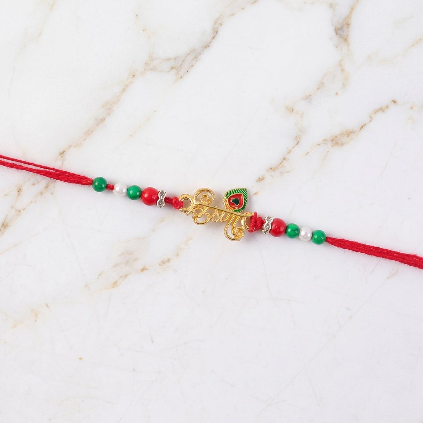 Elegant Rakhi with gold and pearl embellishments for brother's gift