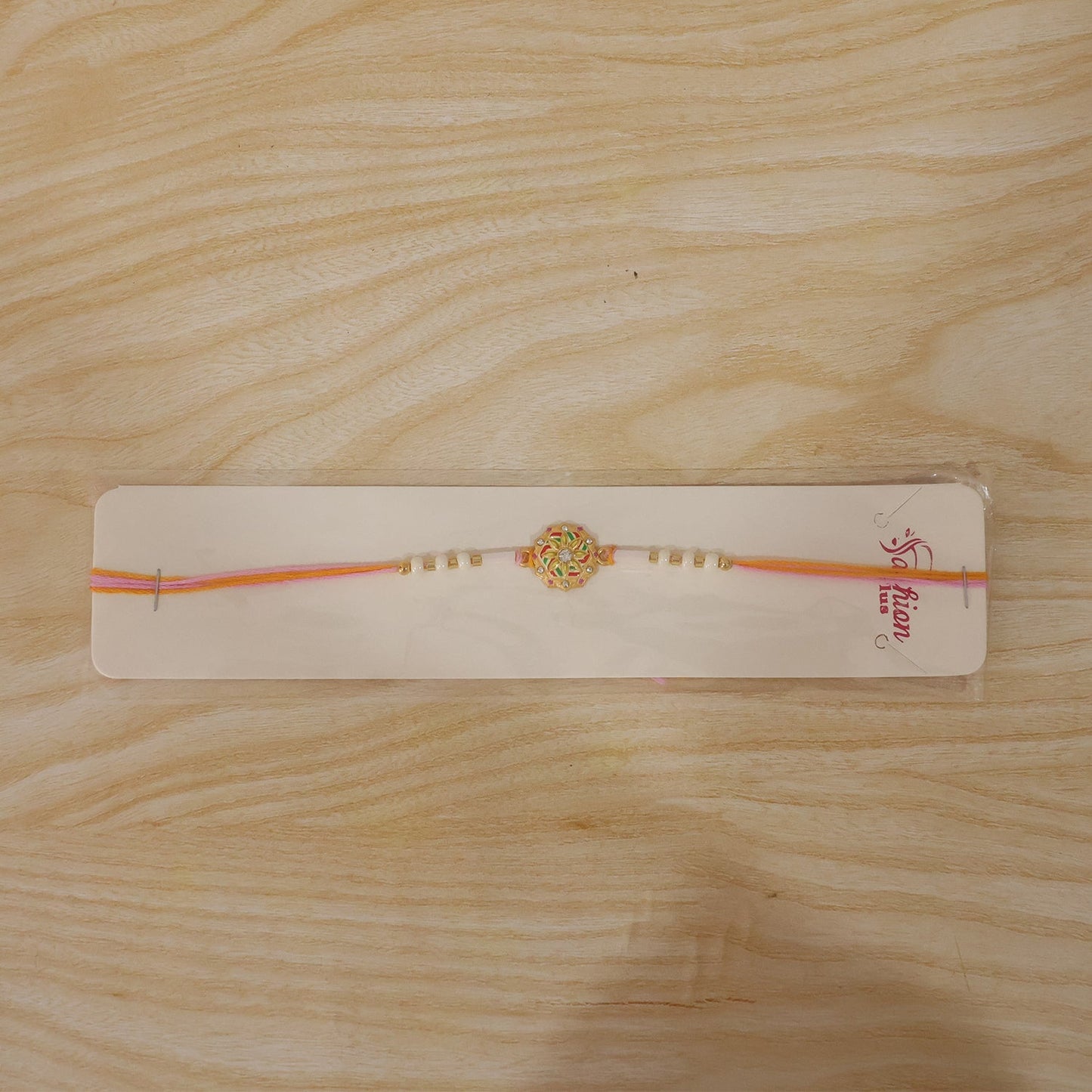 Overhead shot of festive Meenakari Rakhi for brother.
