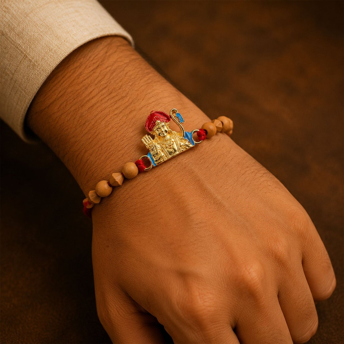 Side view of designer Rakhi with natural sandalwood beads and golden embellishments.