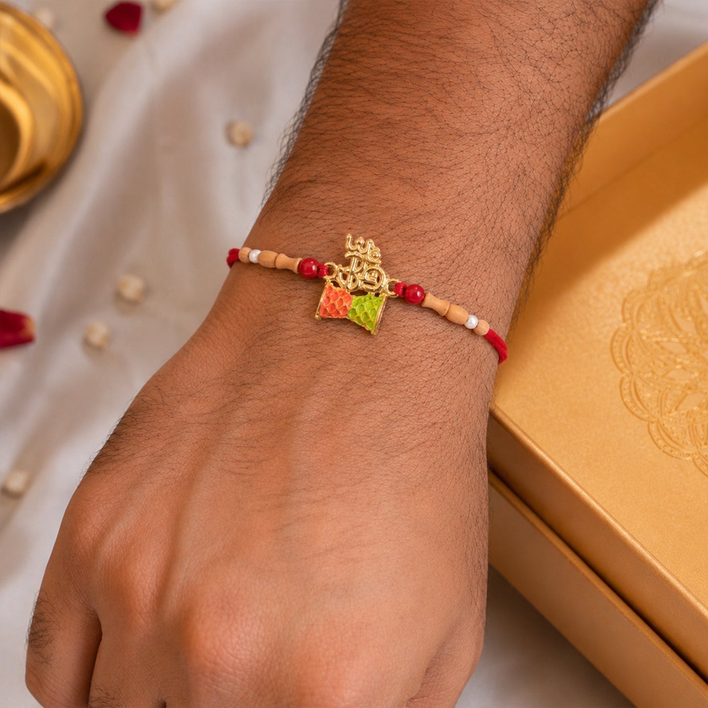 Brother wearing the designer Om Rakhi on wrist for Raksha Bandhan.