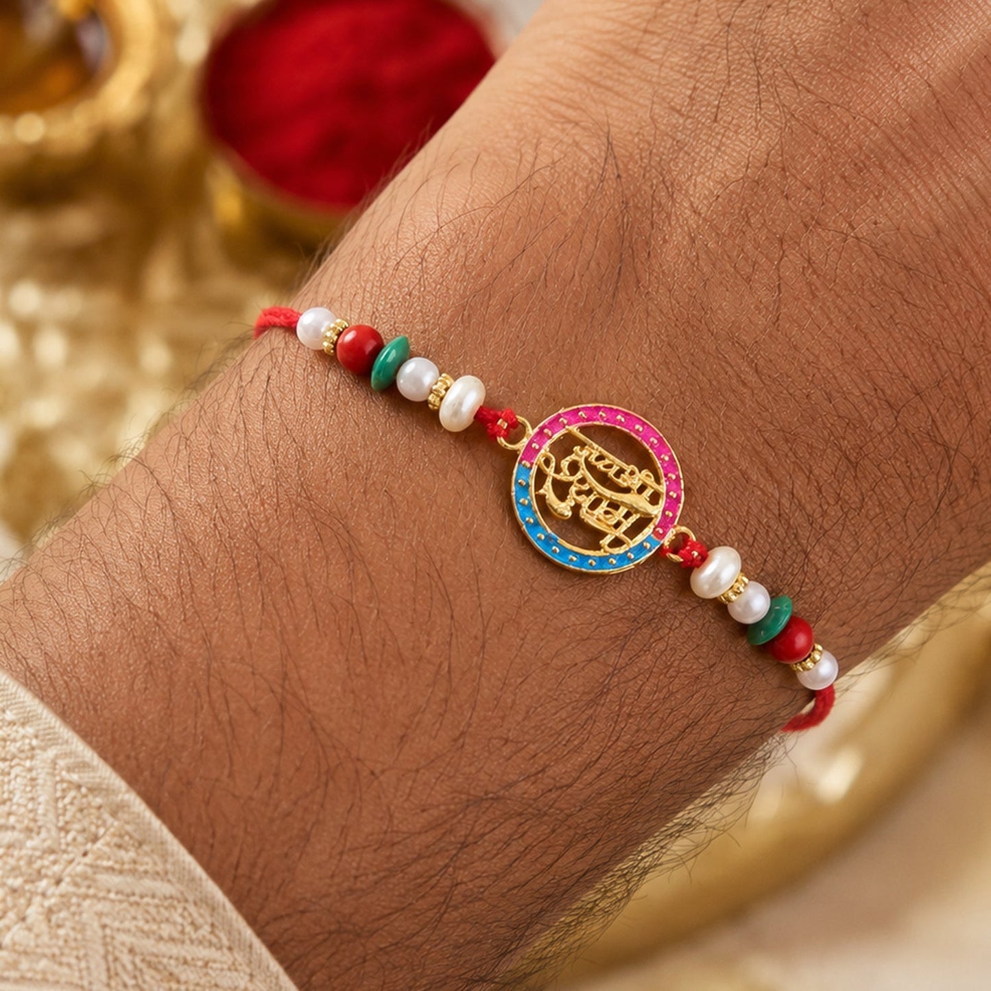 Pearl-embellished Rakhi with divine Hindi text, angled view