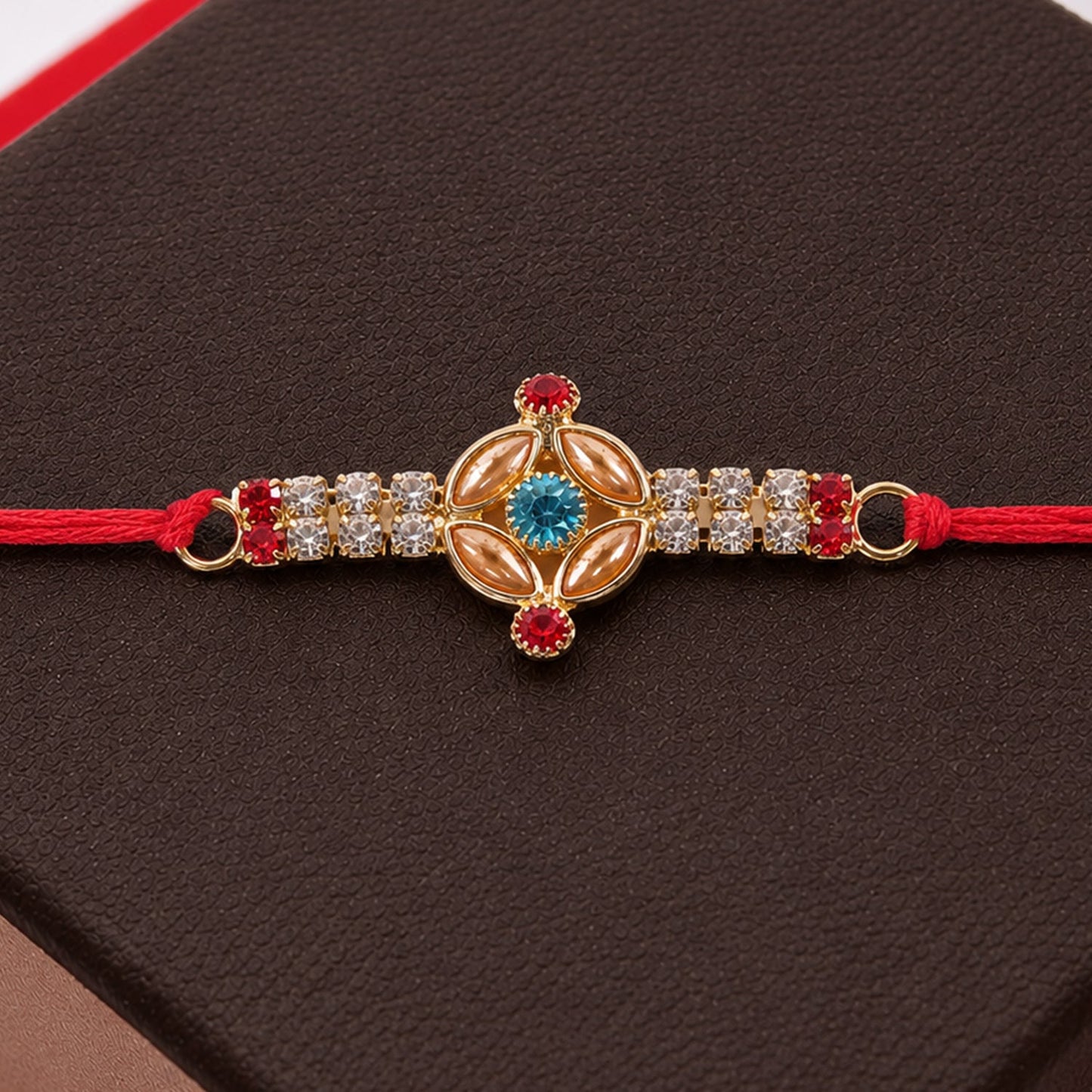 Elegant gold floral Kundan Rakhi with turquoise accents, perfect for brothers during Raksha Bandhan.