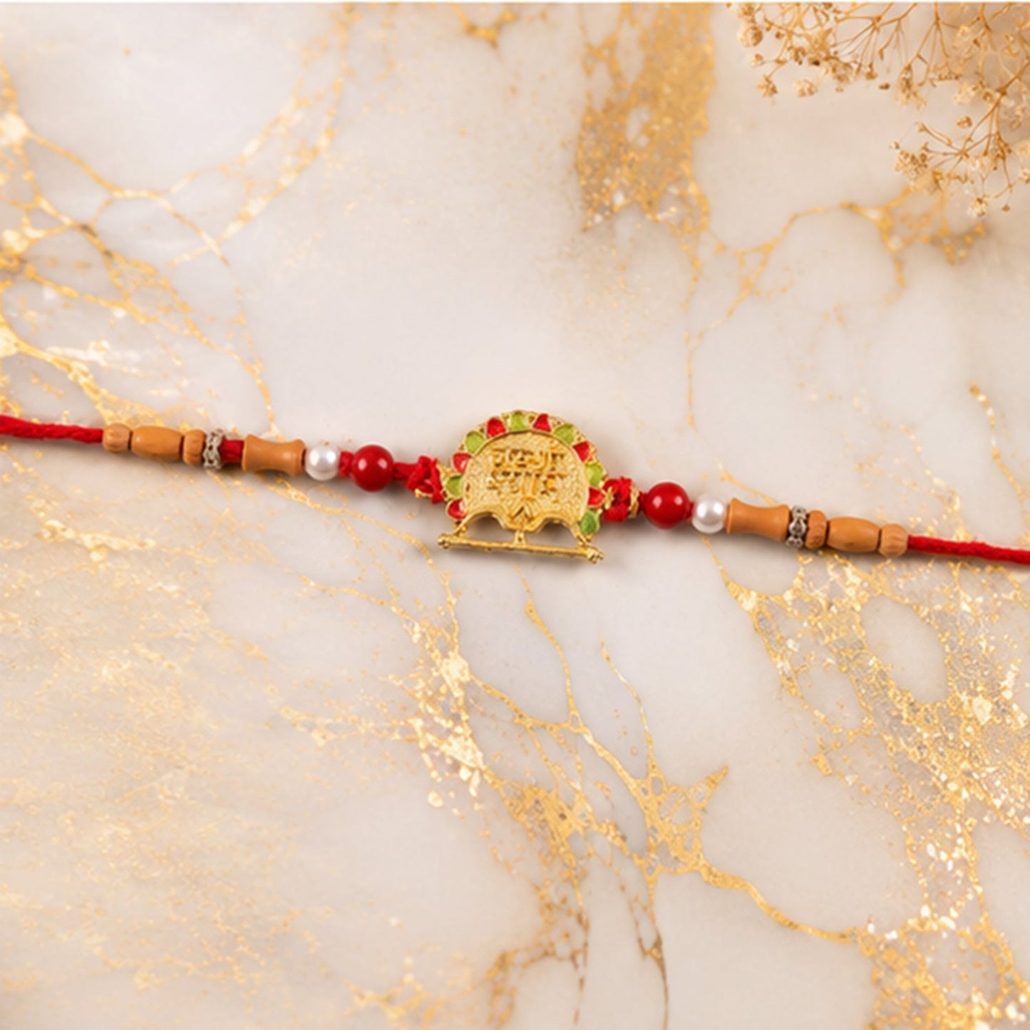 Side view of premium Meenakari Rakhi with vibrant thread.