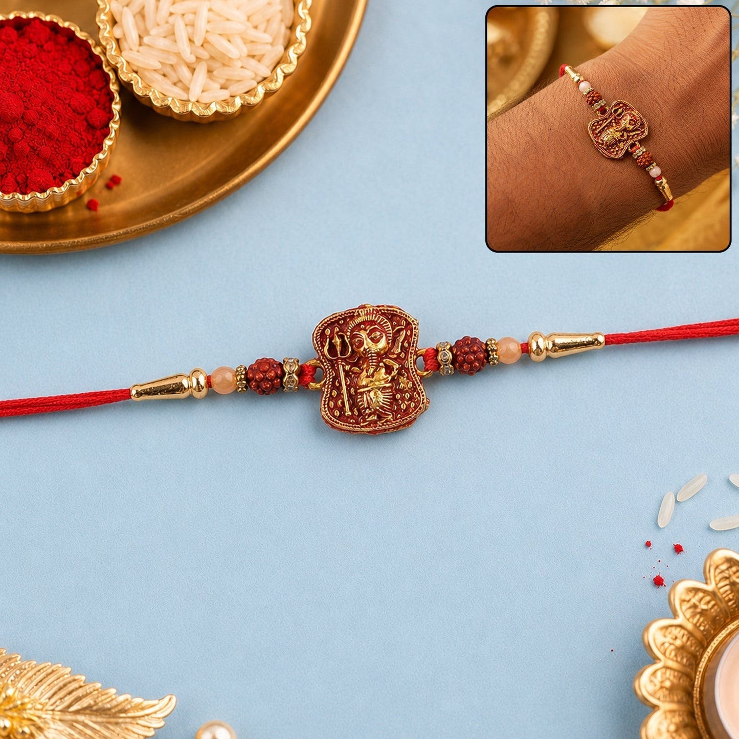 Close-up of the Ganesha Rudraksha Rakhi with antique Lord Ganesha idol and brown Rudraksha beads.