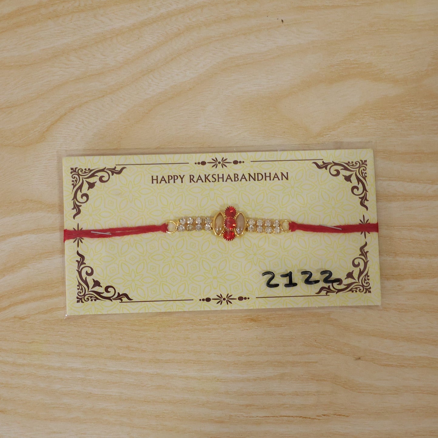 Back view of traditional thread on gold Rakhi