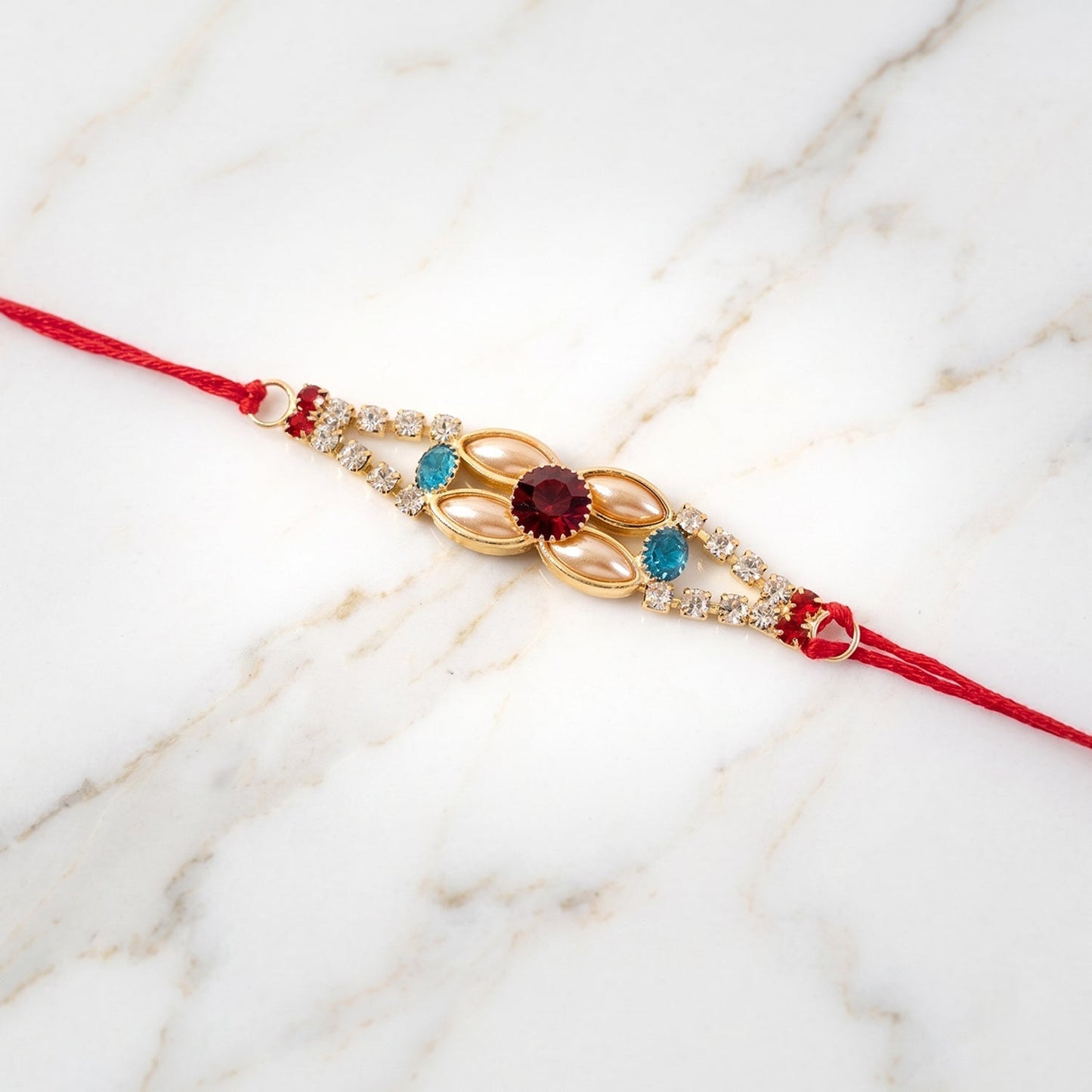 Gift-ready AD Stone floral Rakhi in festive packaging.