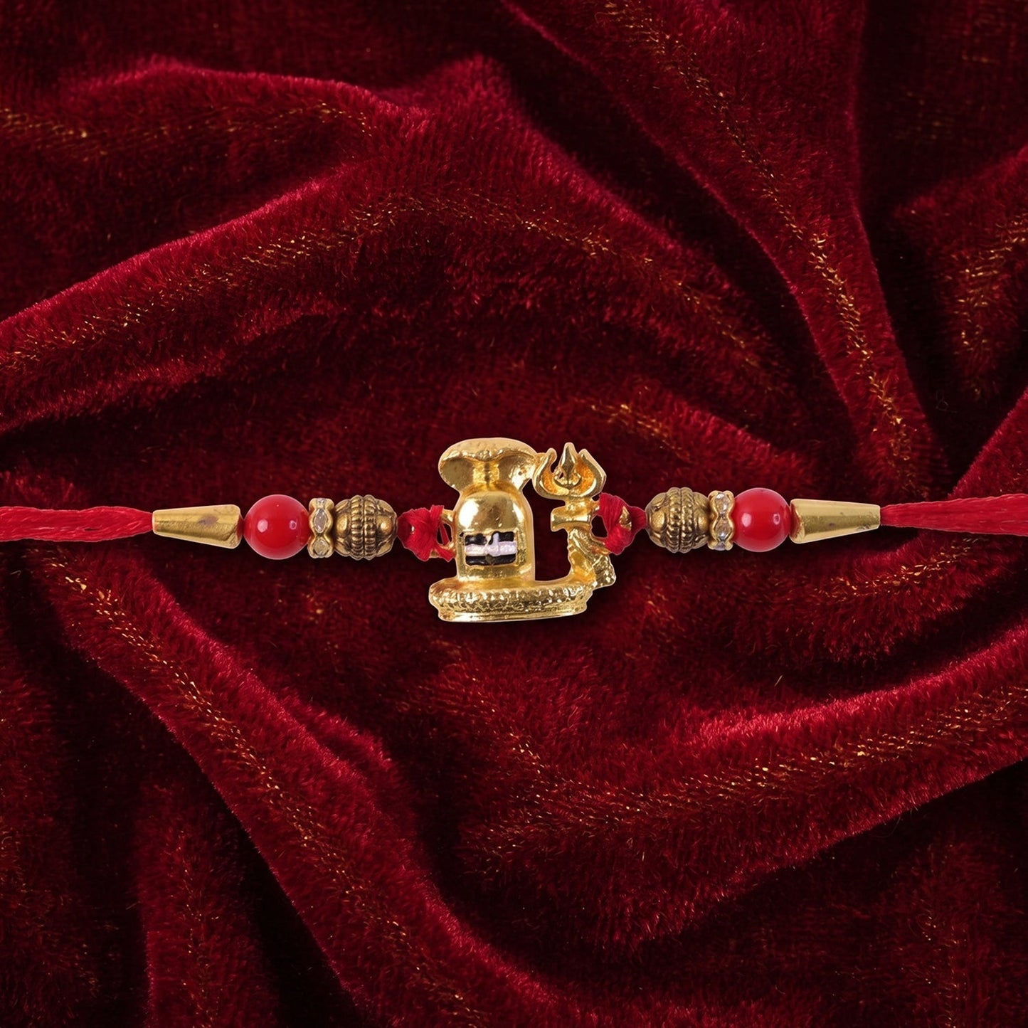 Top-down view of the traditional Shivling Rakhi, showcasing its golden finish.