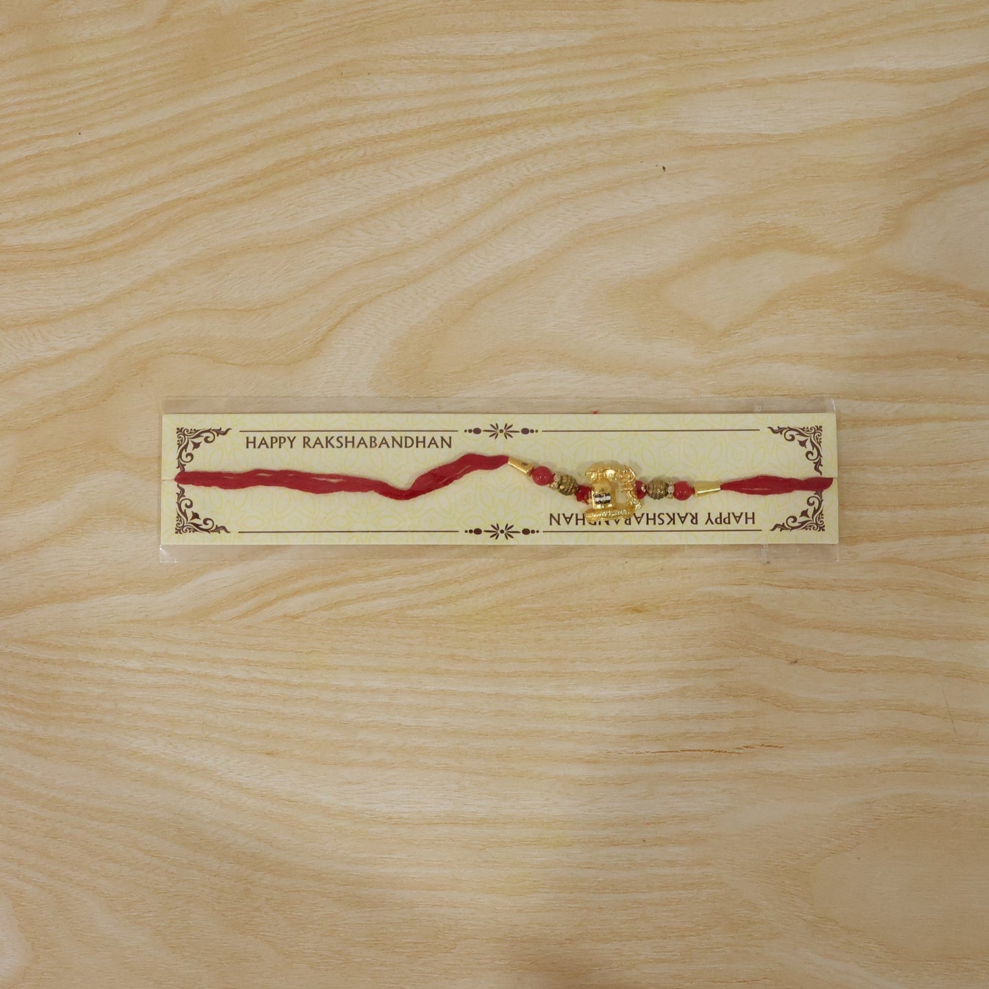 Elegant Shivling Rakhi with red beads, perfect for Raksha Bandhan.