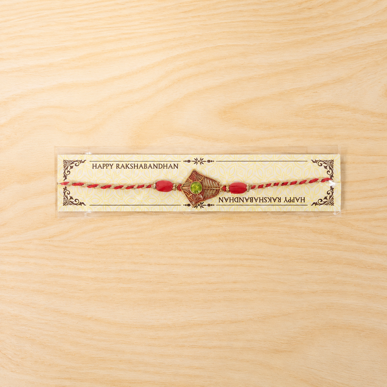 Side view of festive green stone Rakhi for brothers.