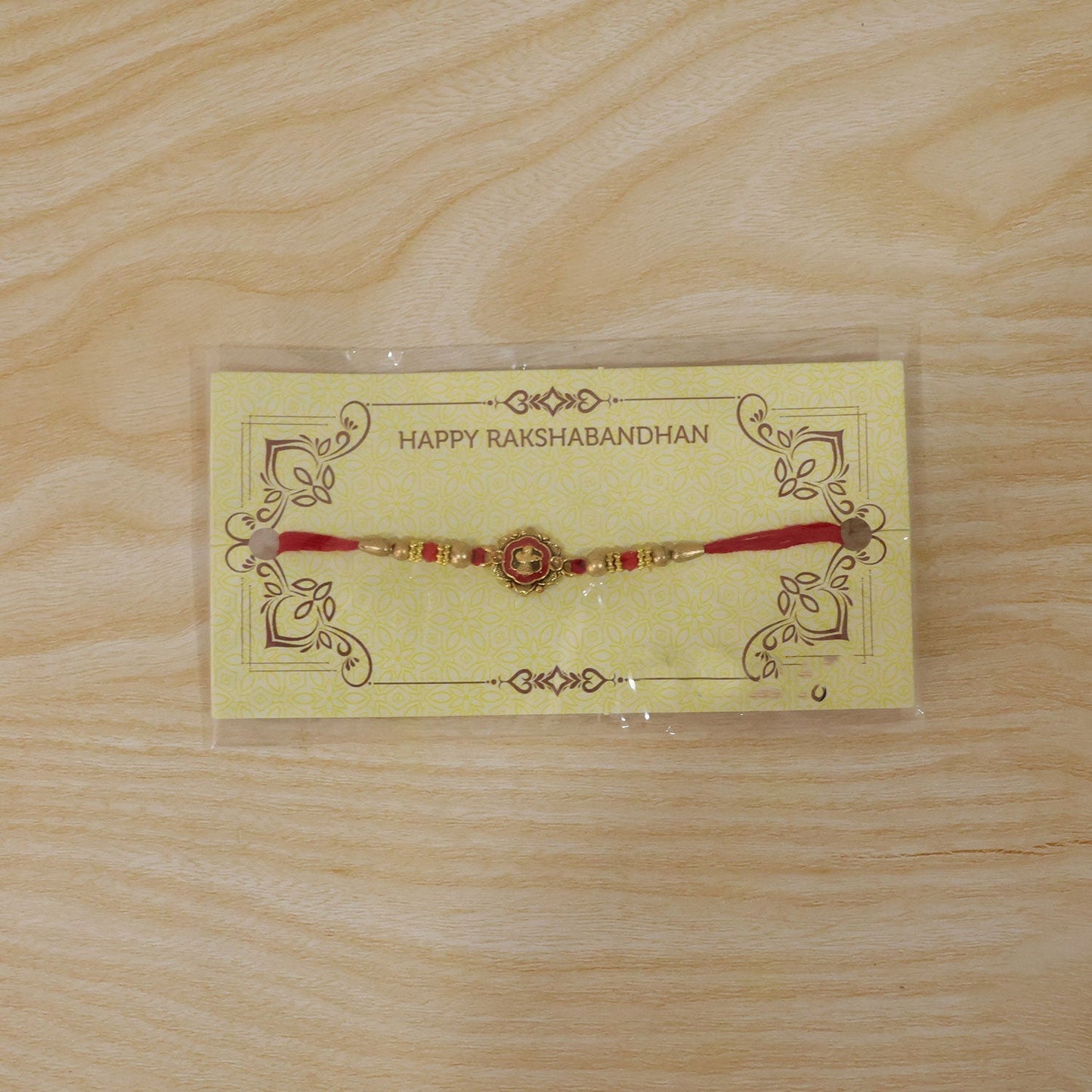 Another angle of the golden floral Rakhi showcasing its elegance.