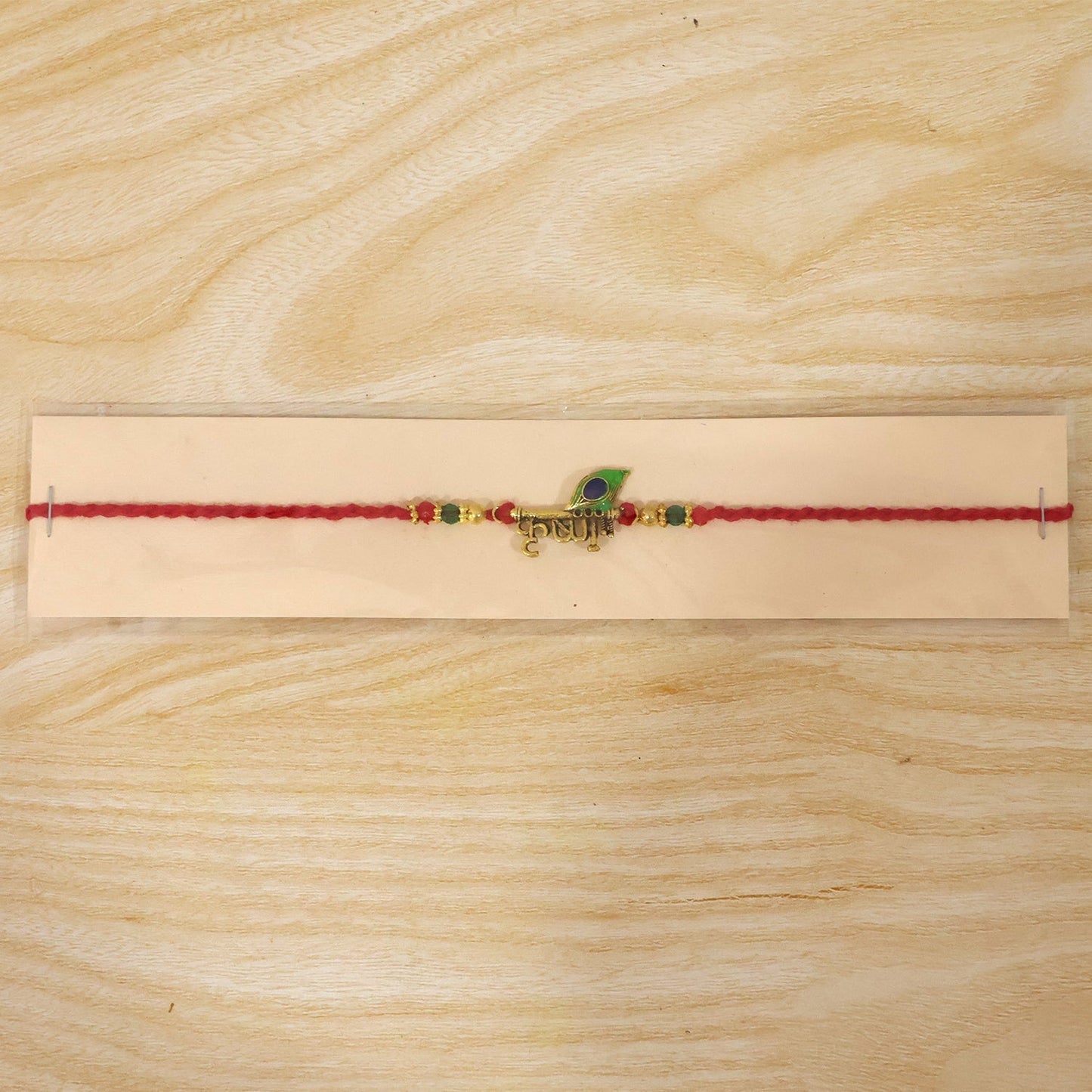 Lord Krishna Rakhi displayed with festive Indian backdrop for Raksha Bandhan.