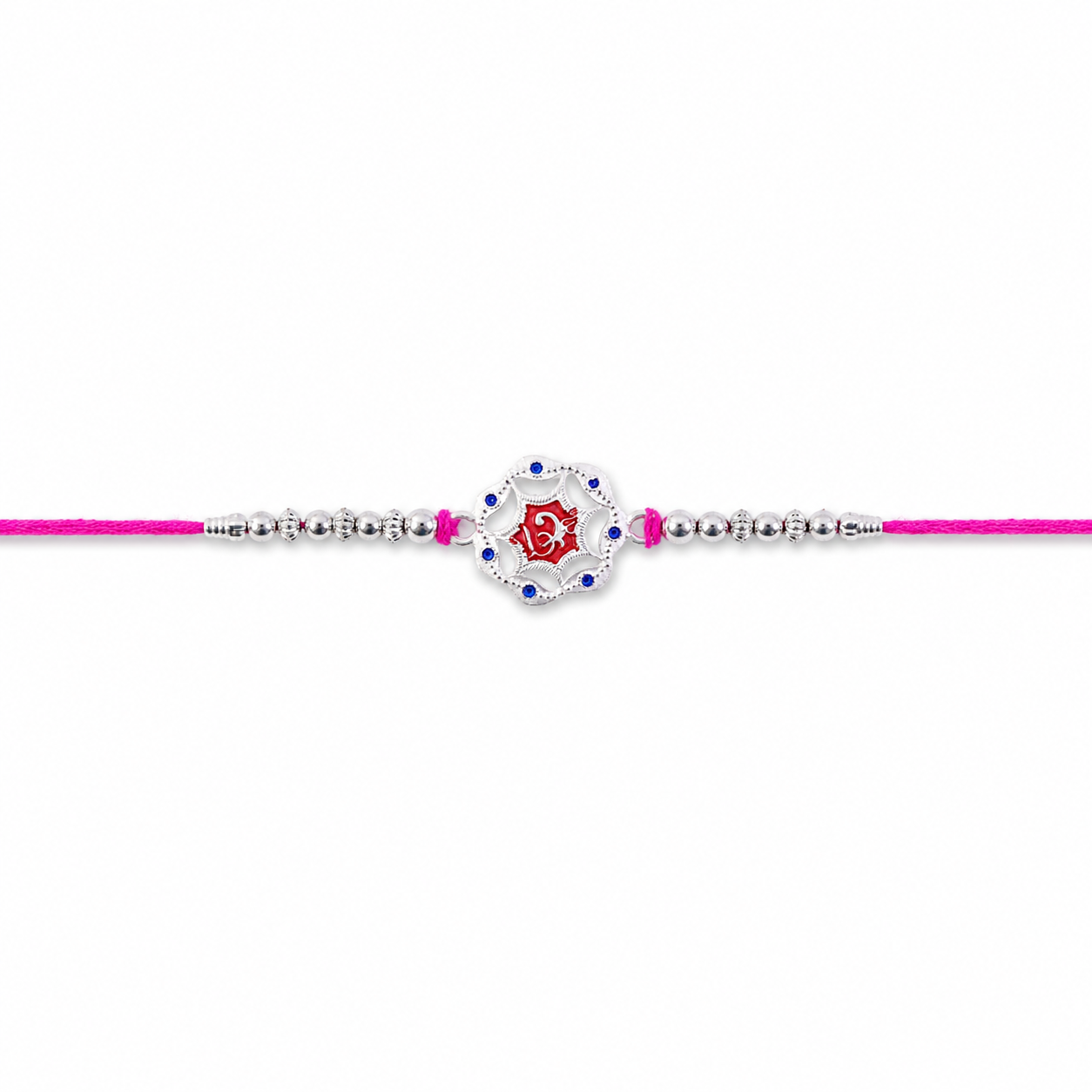 Top-down perspective of the beautiful silver-tone rakhi, highlighting the red stone.