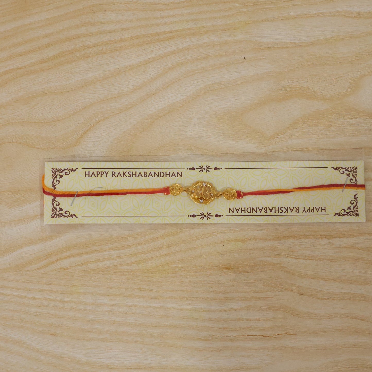 Overhead view of the Golden Om Rakhi, ready for the Raksha Bandhan celebration.