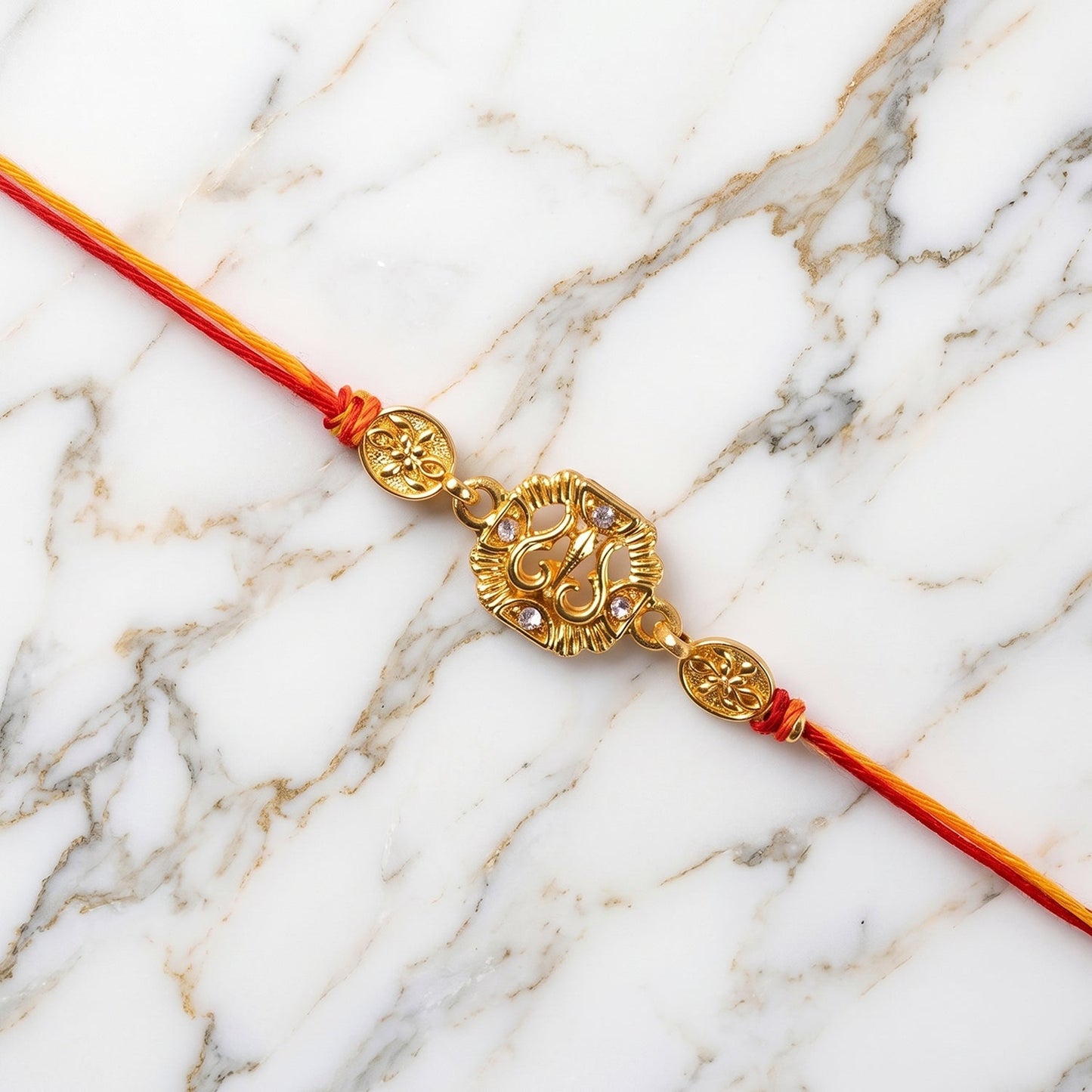 Full view of the Traditional Rakhi for brother, showcasing its golden charm and red thread.
