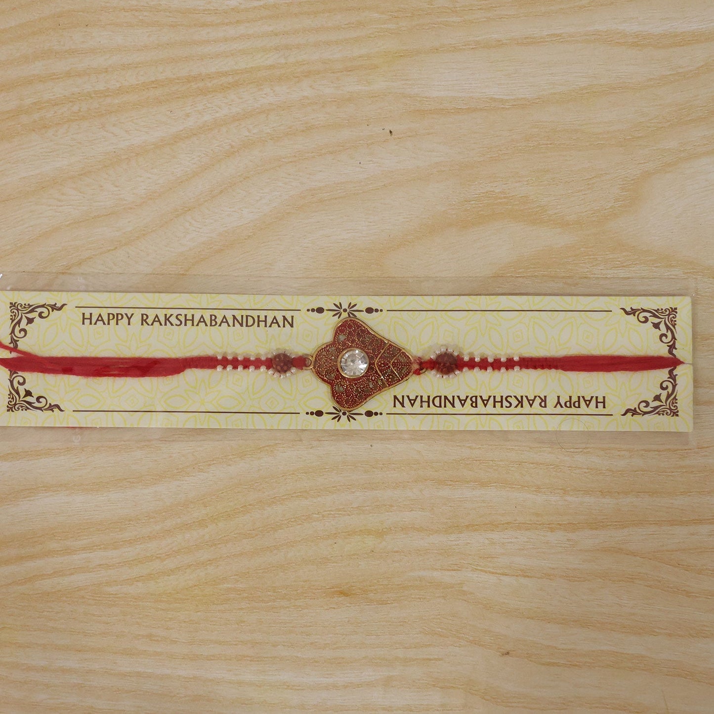 Back view of the floral Meenakari Rakhi showing the thread.