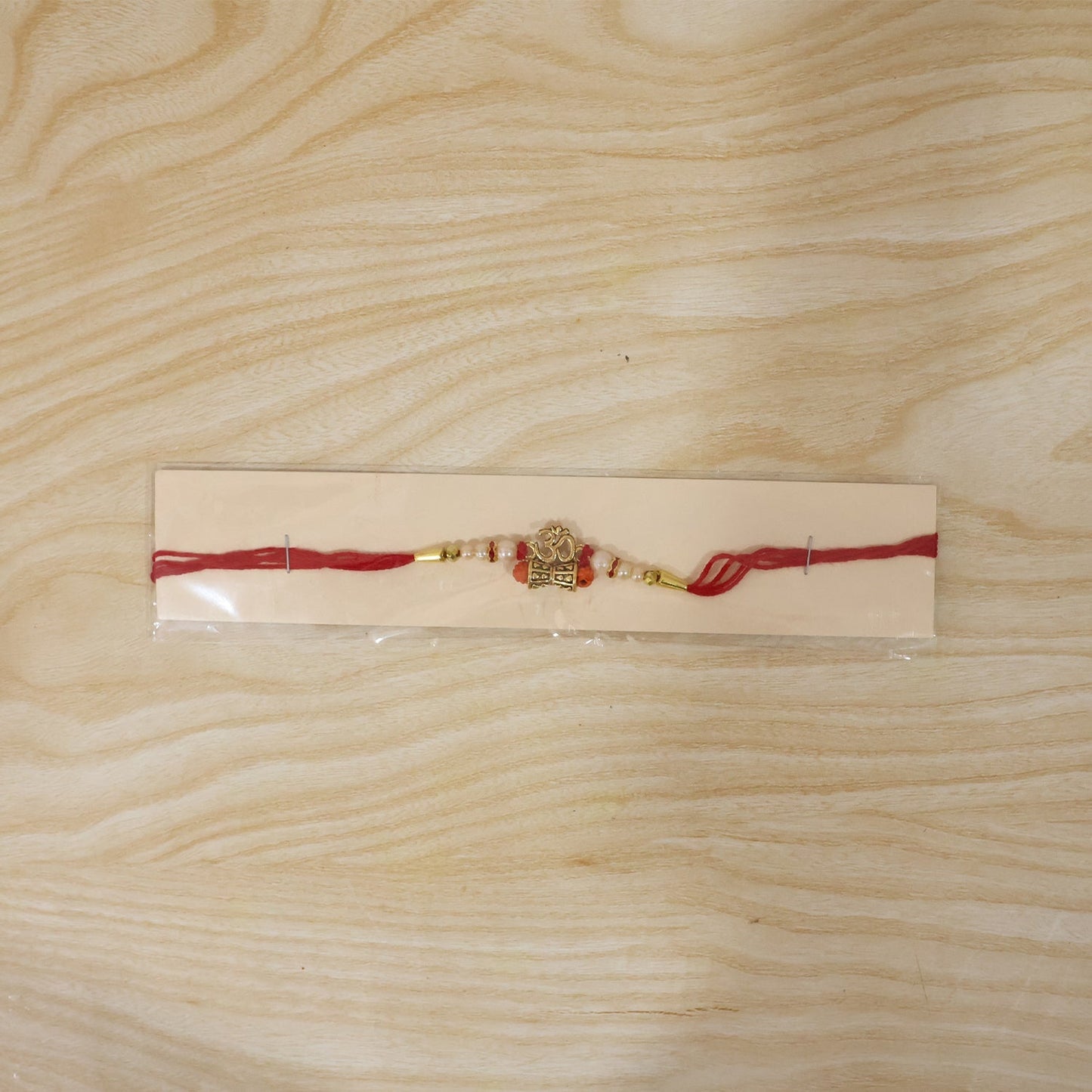 Celebratory Om Rudraksha Rakhi with pearls, ready for Rakshabandhan gift.