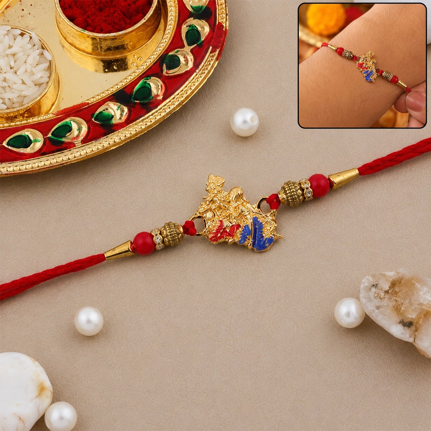 Golden Peacock designer Rakhi with intricate blue enamel work and red bead details