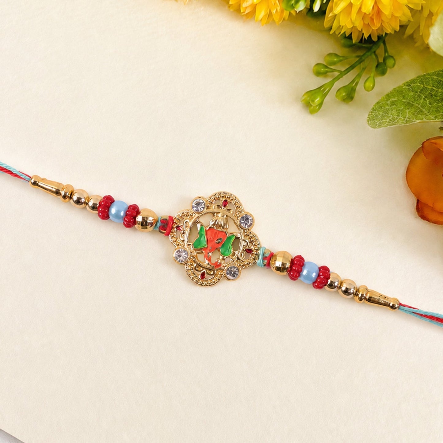 Close-up of kundan work and peacock motif on the rakhi.
