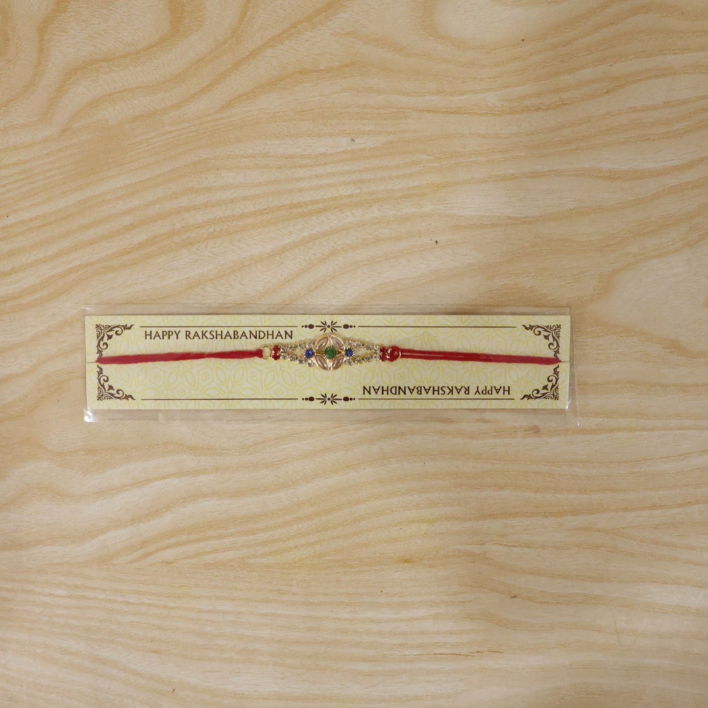Kundan floral Rakhi displayed on a white surface