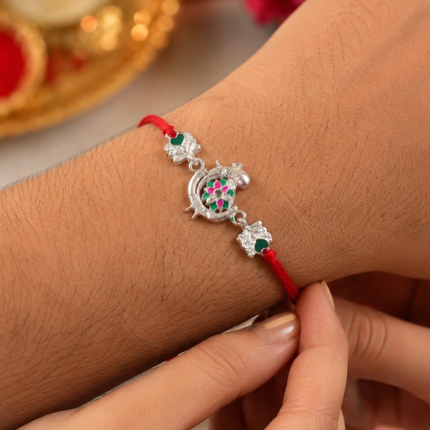 Decorative peacock themed rakhi with beads and enamel work in vibrant colors