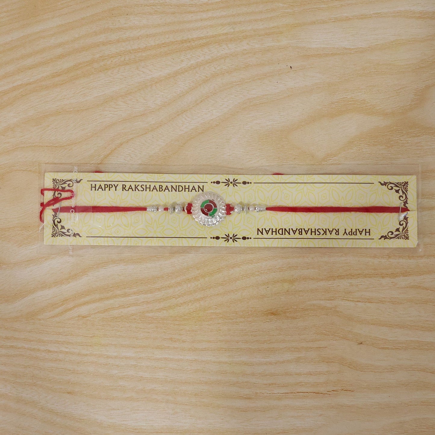 Stylish festive Rakhi with silver meenakari and decorative beads for Raksha Bandhan