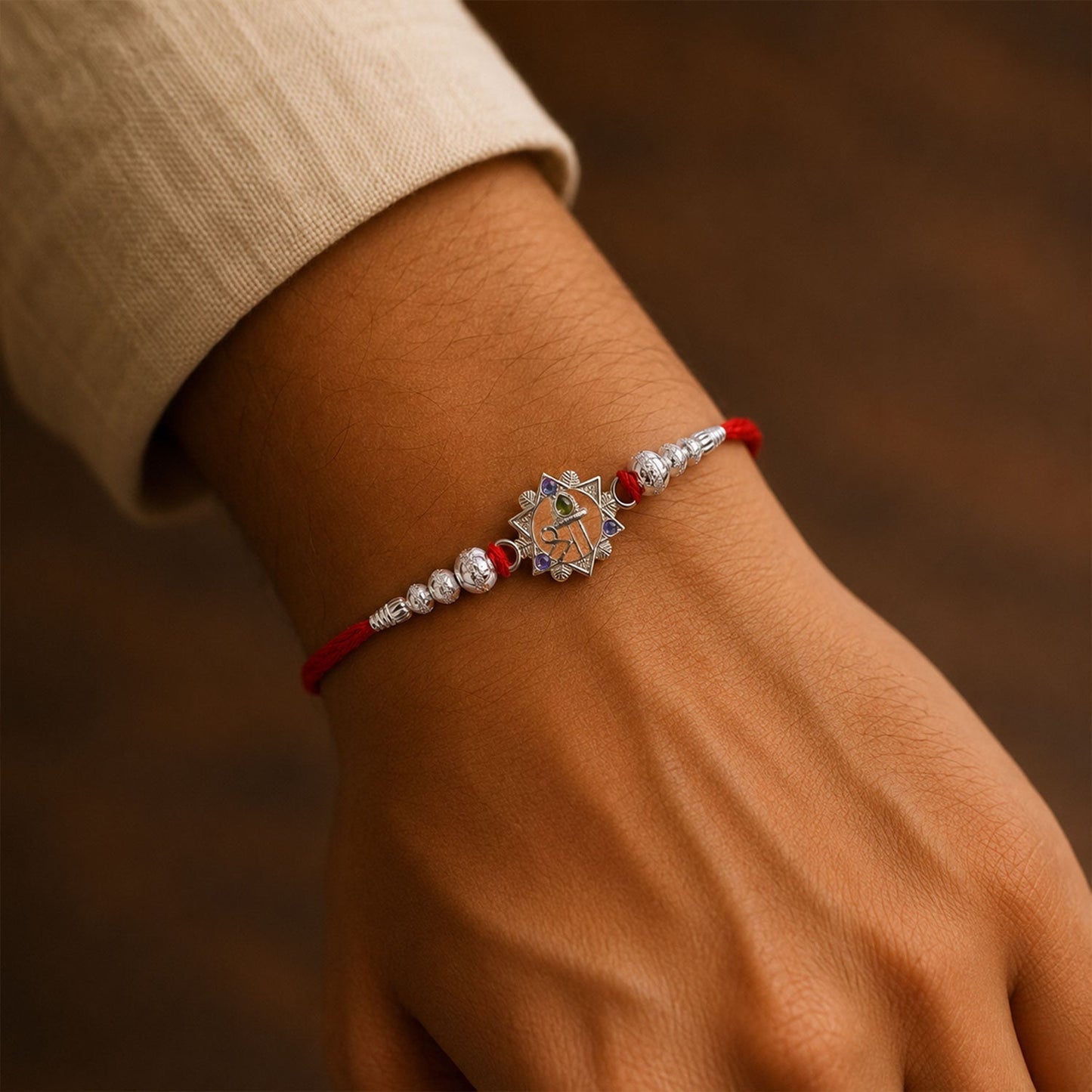 Close-up of Silver Swastik Rakhi with intricate detailing