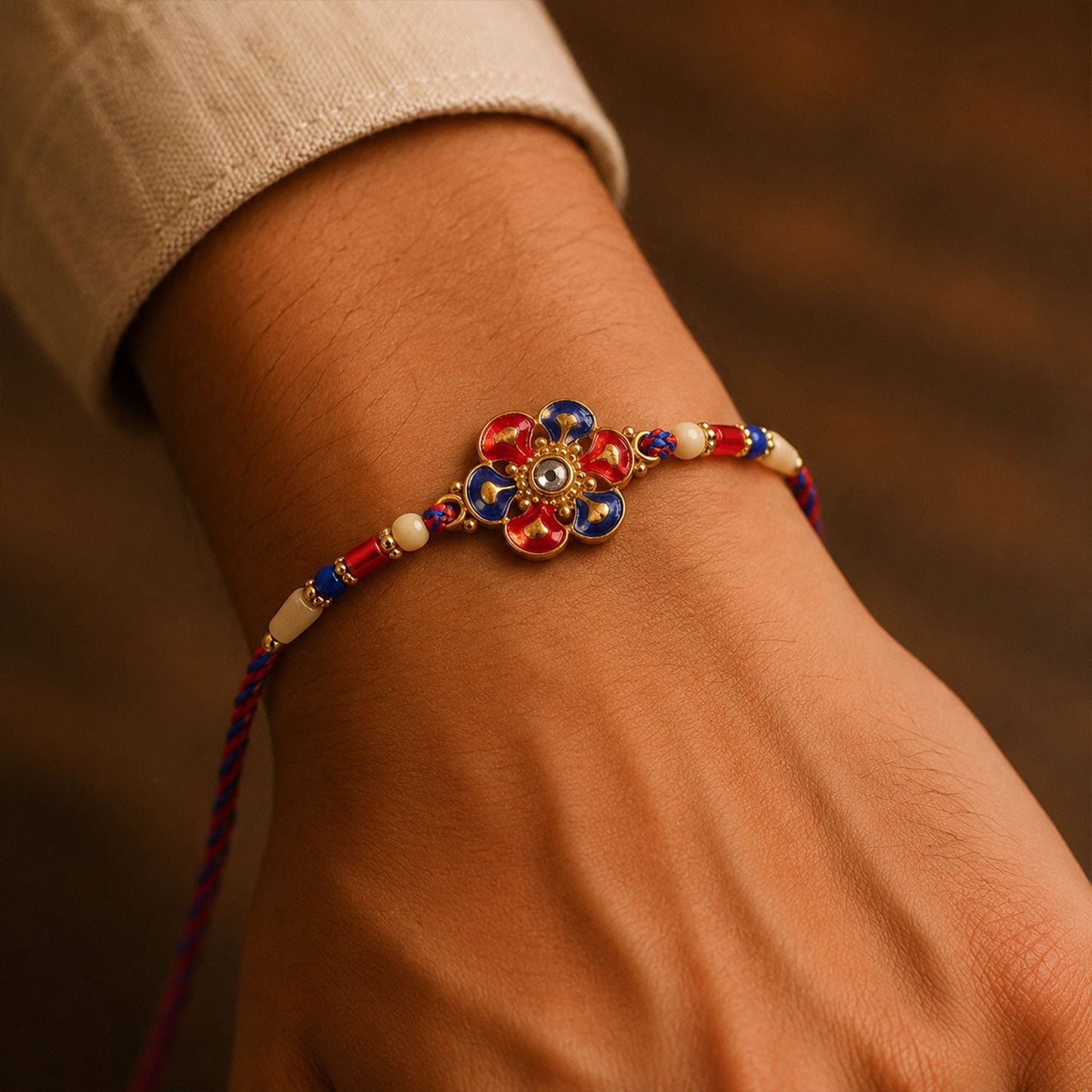 Decorative pearl beaded Rakhi featuring floral meenakari design for brothers