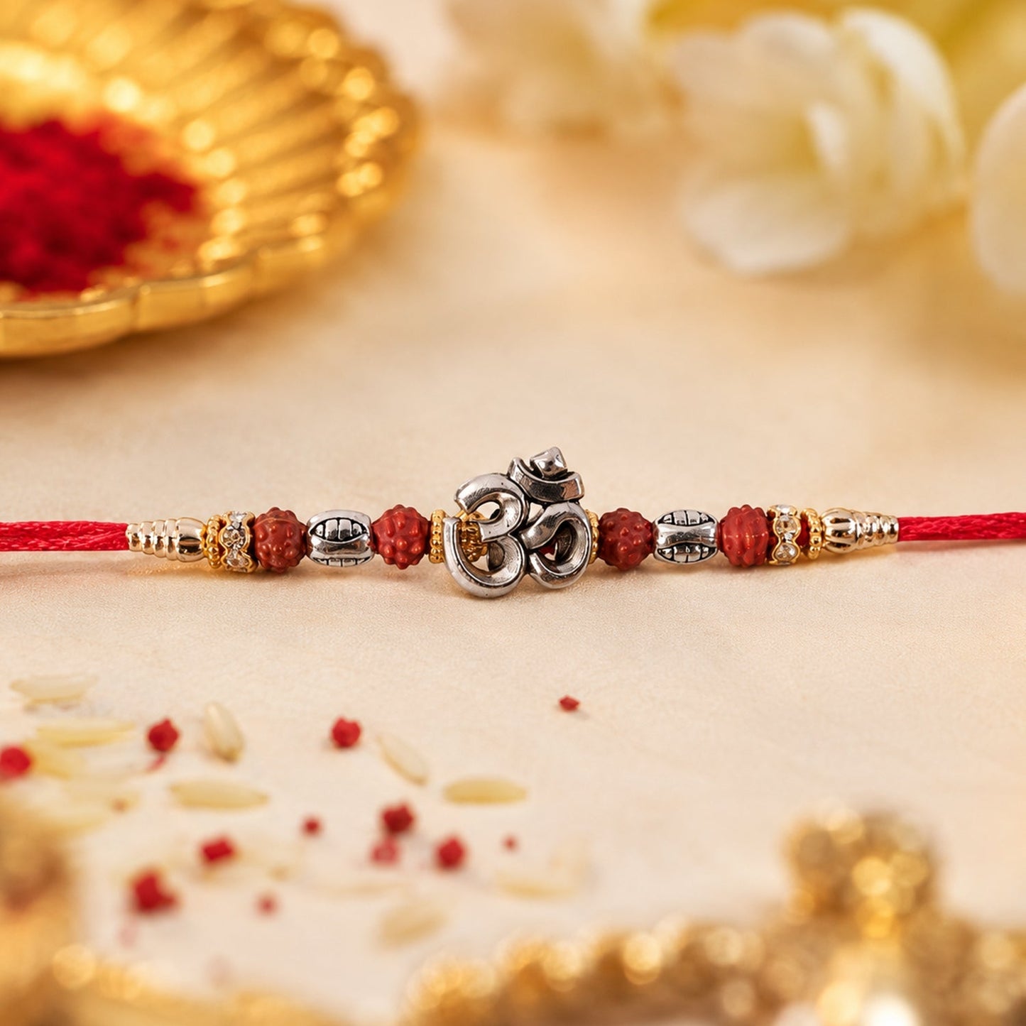 Side view of the designer Om Rudraksha Rakhi, showcasing its craftsmanship.