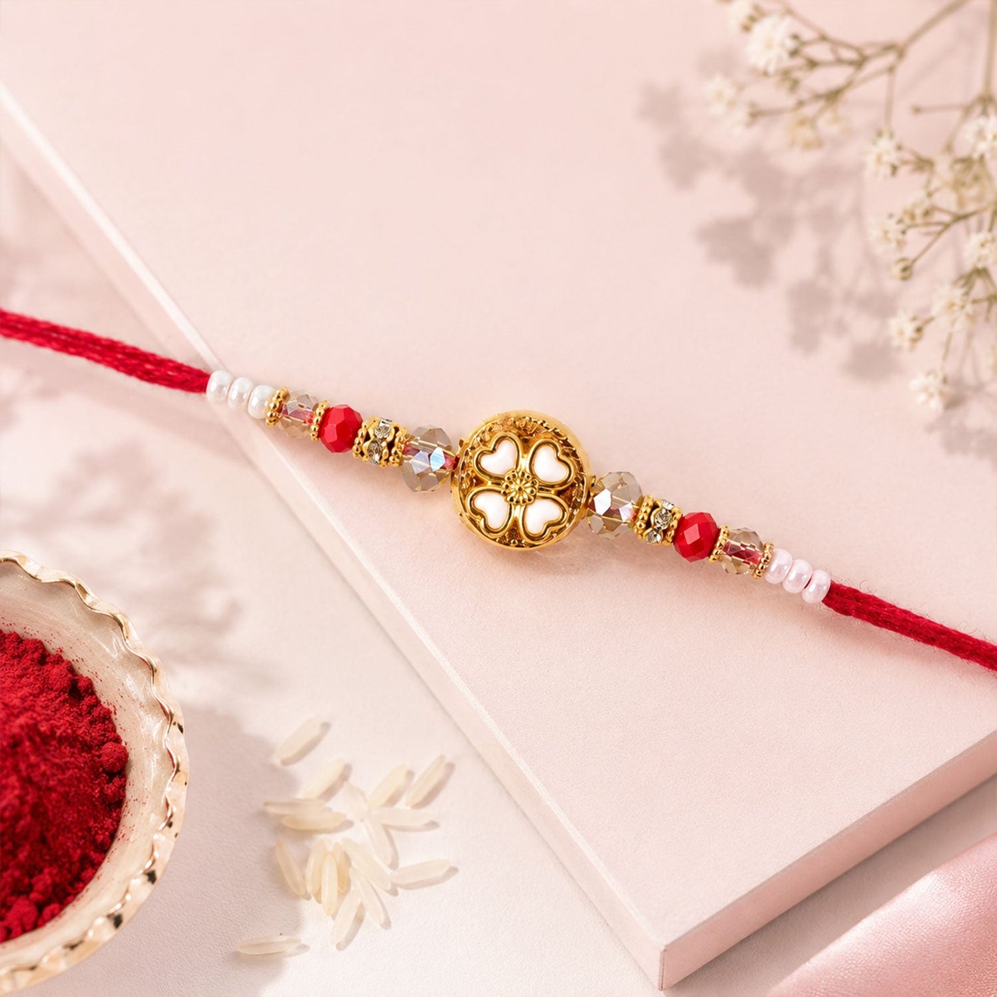 Stylish golden floral rakhi on white background, perfect for gift or ritual