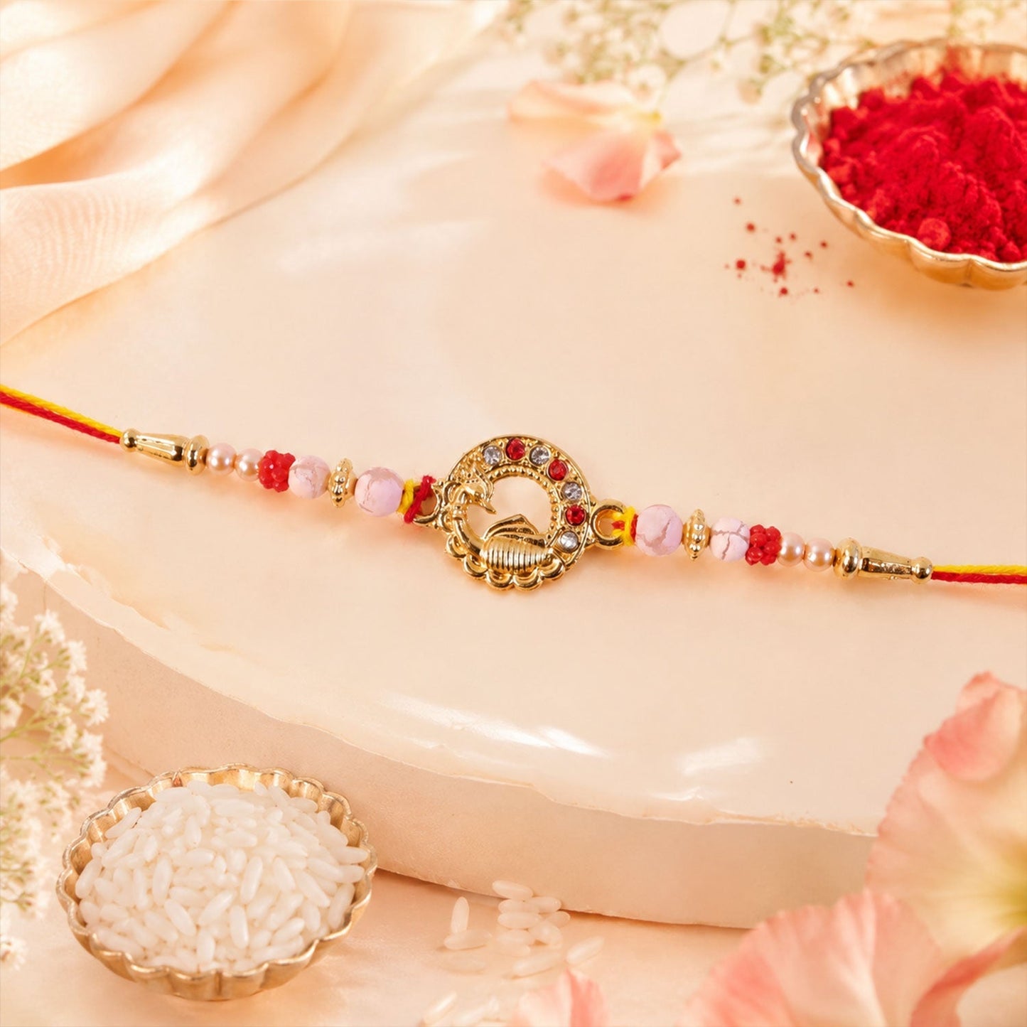 Elegant golden peacock rakhi with intricate pearls and beads.