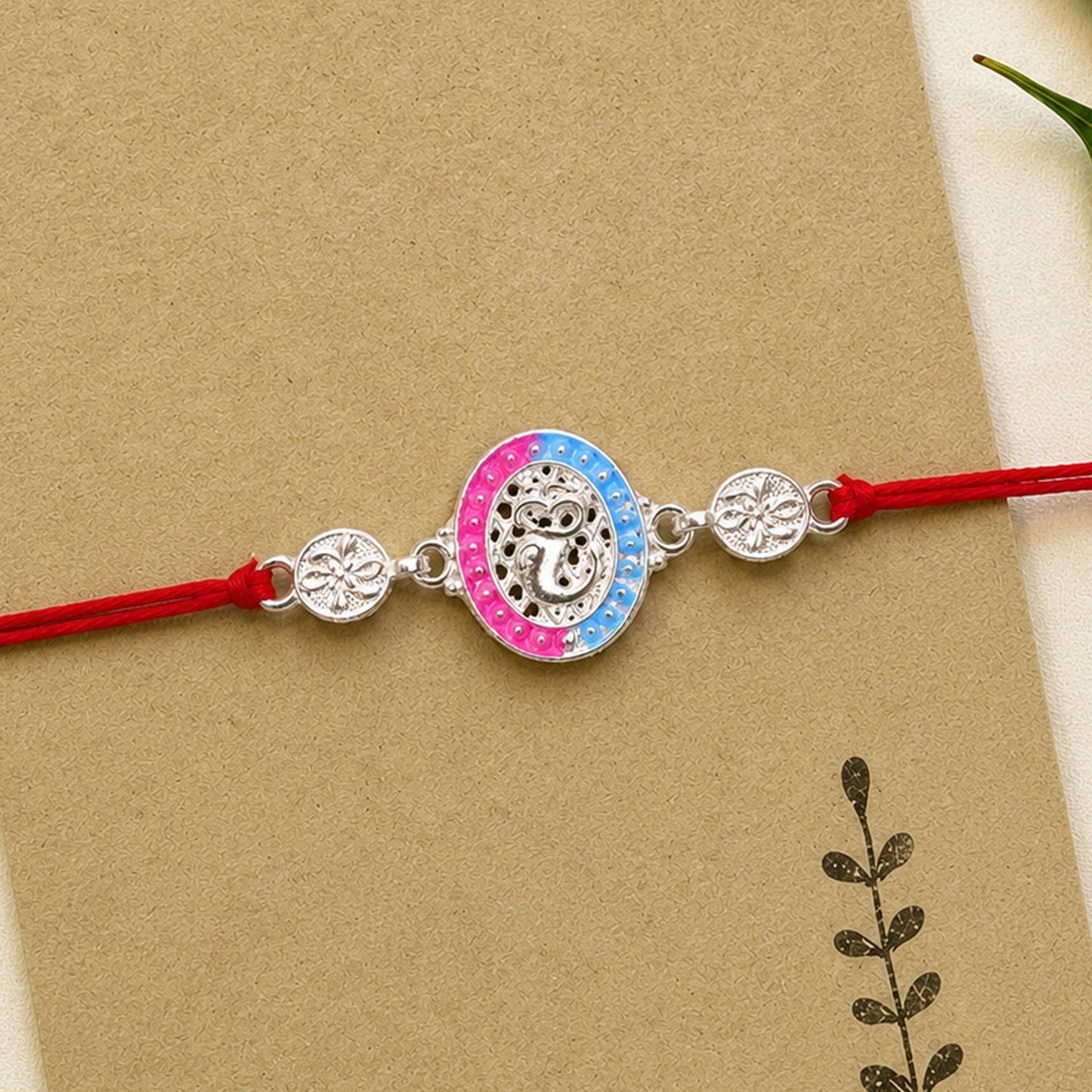 Elegant Silver Meenakari Rakhi with vibrant pink and blue enamel accents