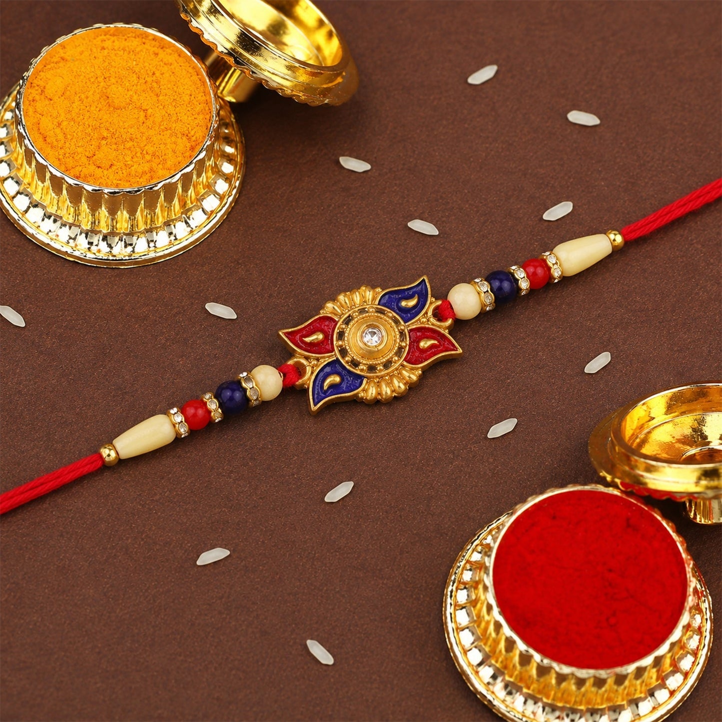 Thread detail of red blue floral kundan rakhi