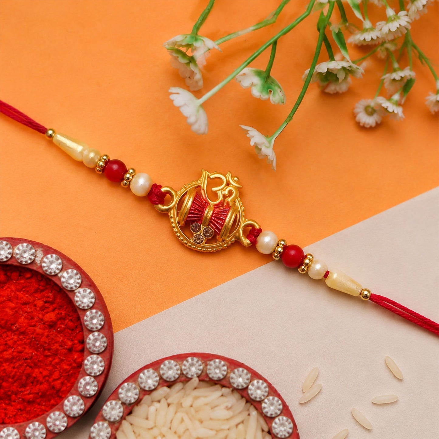 Side detailed view of Om Damaru Charm Rakhi with pearl beads.