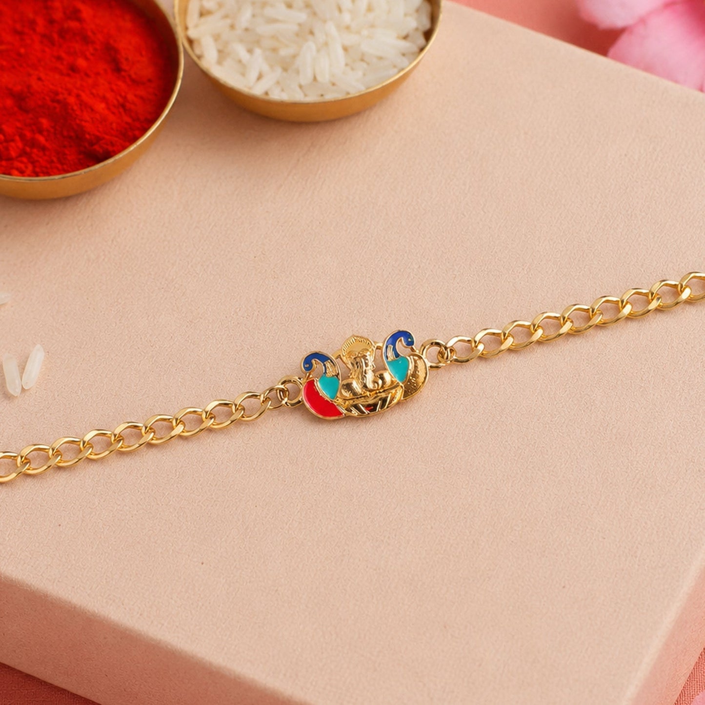 Close-up of Peacock Ganesh charm and beads on rakhi