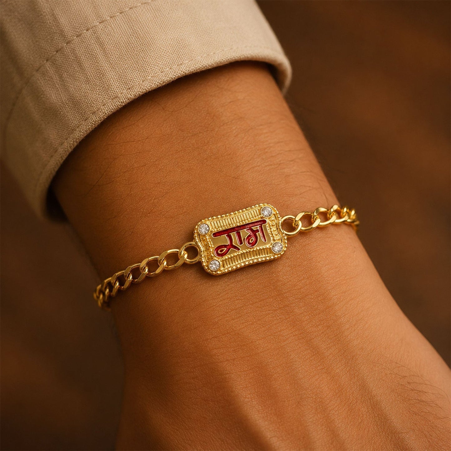 Close-up of Ram Text Enamel Gold Tone Rakhi bracelet with decorative beads