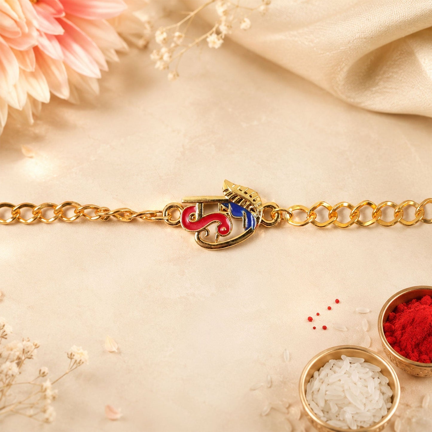 Side view of festive red blue enamel rakhi bracelet
