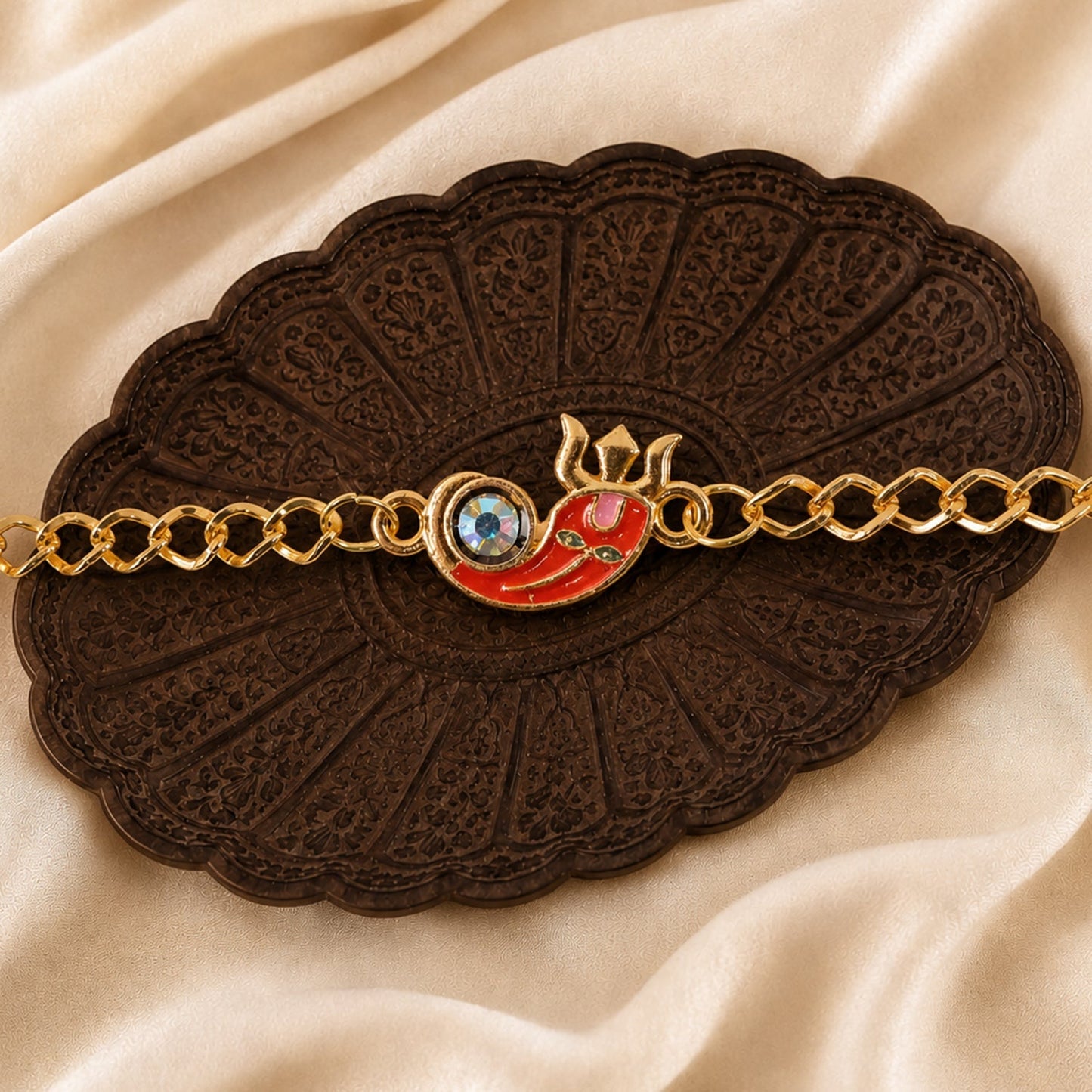 Decorative elements of Ganesha Rakhi bracelet laid flat