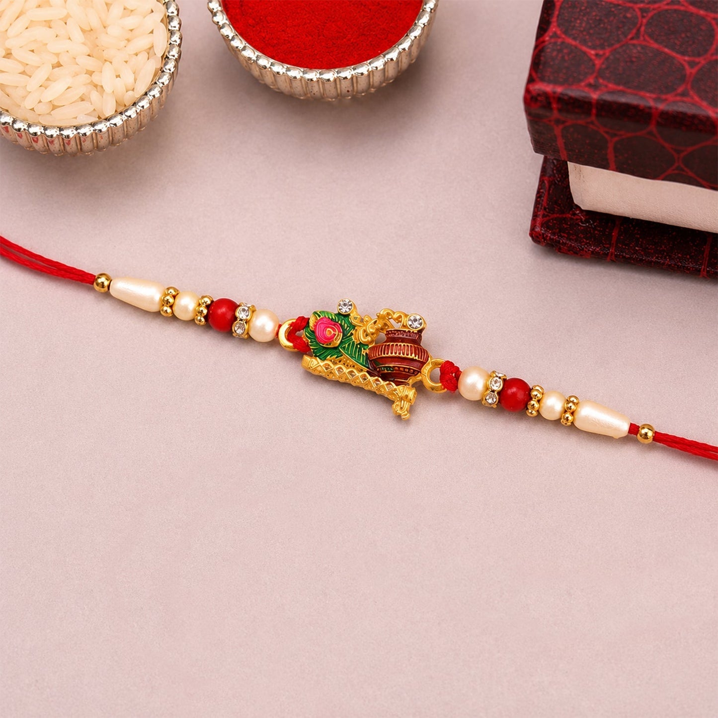 Quality Rakhi with peacock feather and pearl beads, ideal for sibling gift