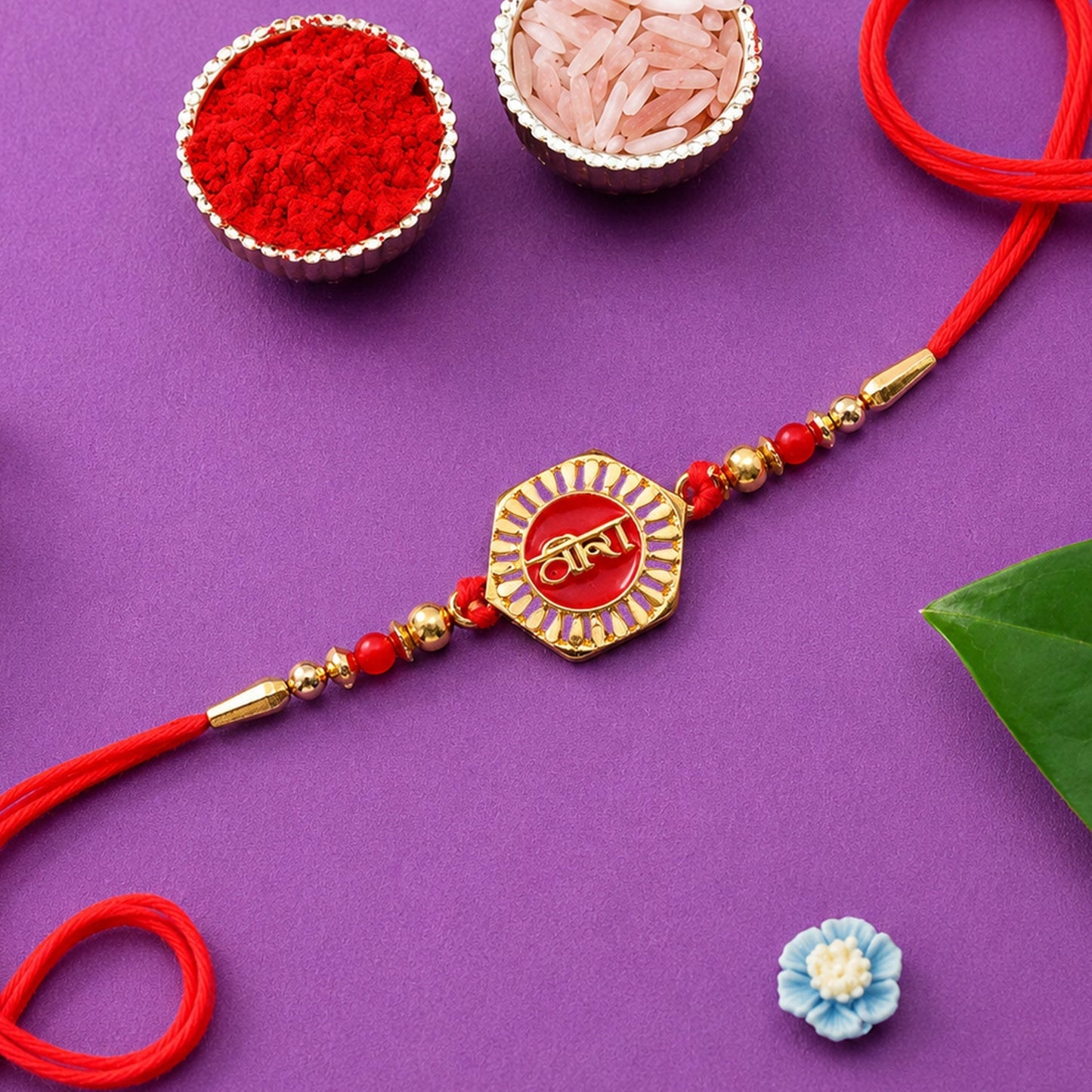 Close-up of Veera Red Enamel Rakhi with gold-tone accents